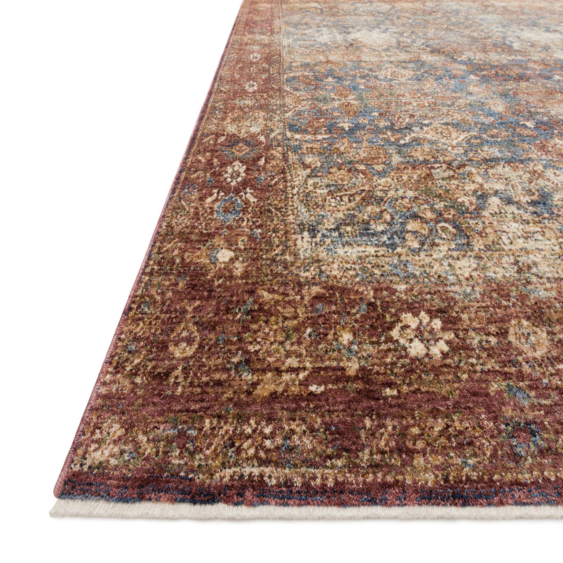 red distressed traditional rug with tan and blue detail