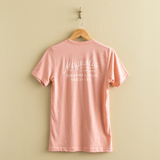 pink-coral t-shirt with "magnolia est 2003" in a cursive script font