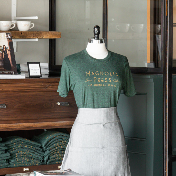 emerald green t-shirt with magnolia press coffee logo in gold across chest