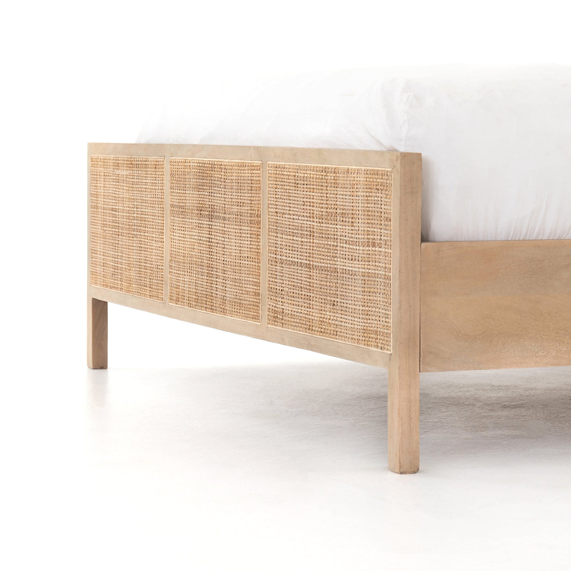 modern natural washed wooden bed with cane detailed headboard and footboard