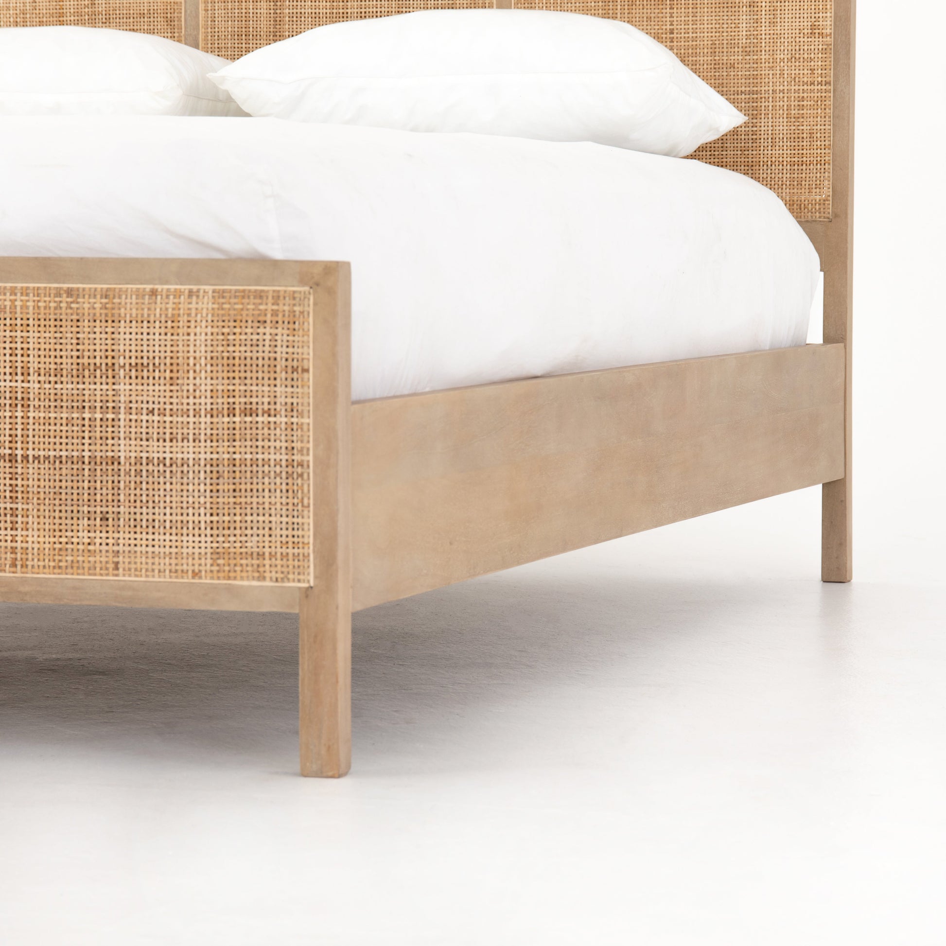 modern natural washed wooden bed with cane detailed headboard and footboard