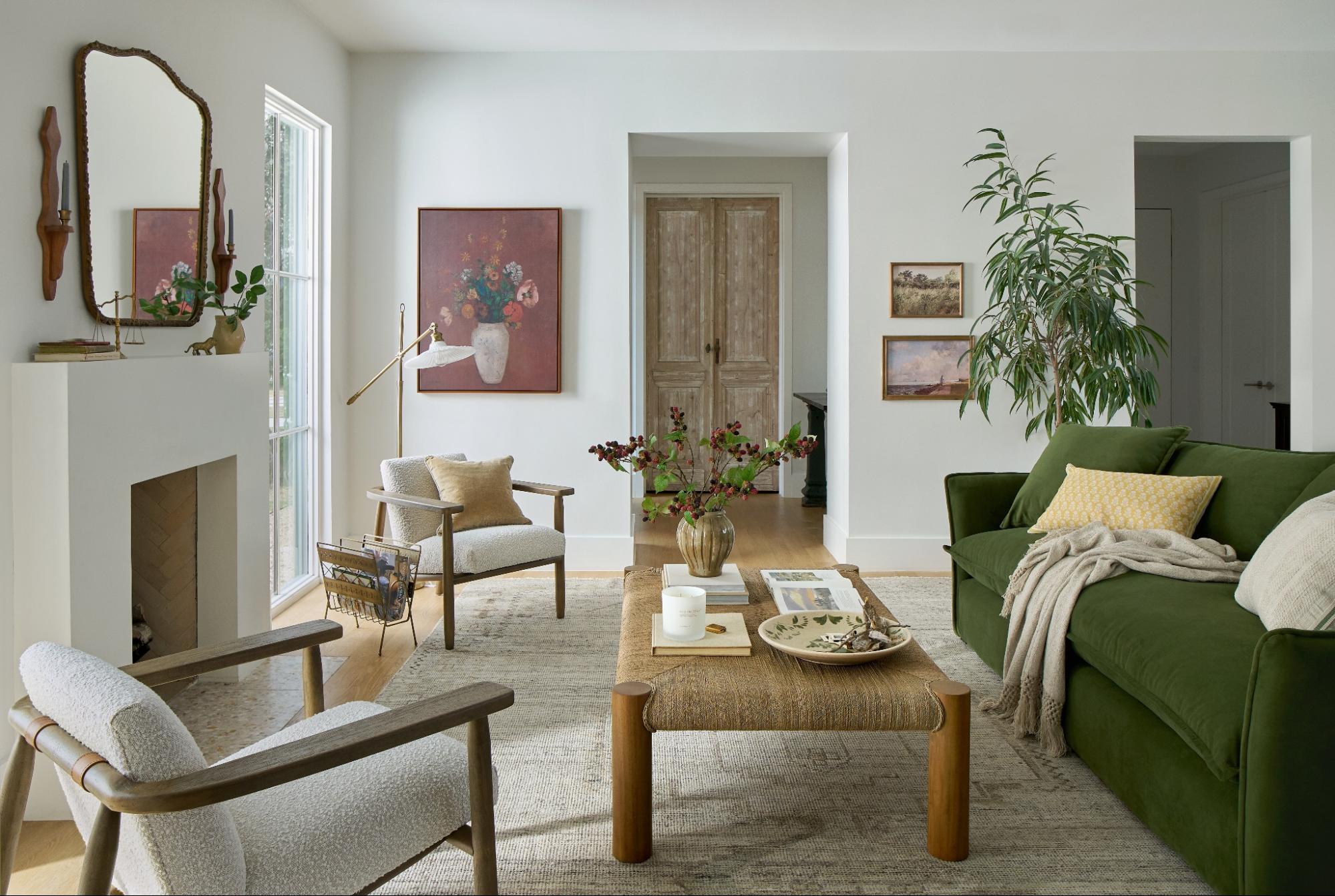 A living room filled with furniture and decor from Magnolia—like a green couch, natural coffee table, mantel mirror, and more.
