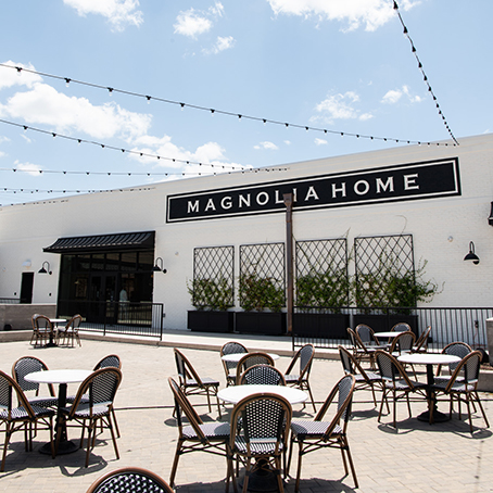 Magnolia Home showroom brick and mortar pictured with tables and chairs outside