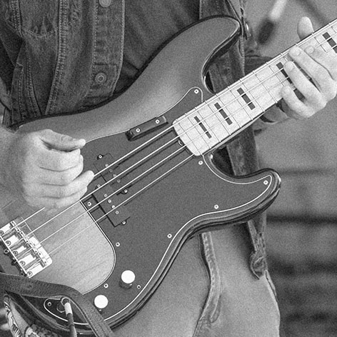 Person strumming an electric guitar.  