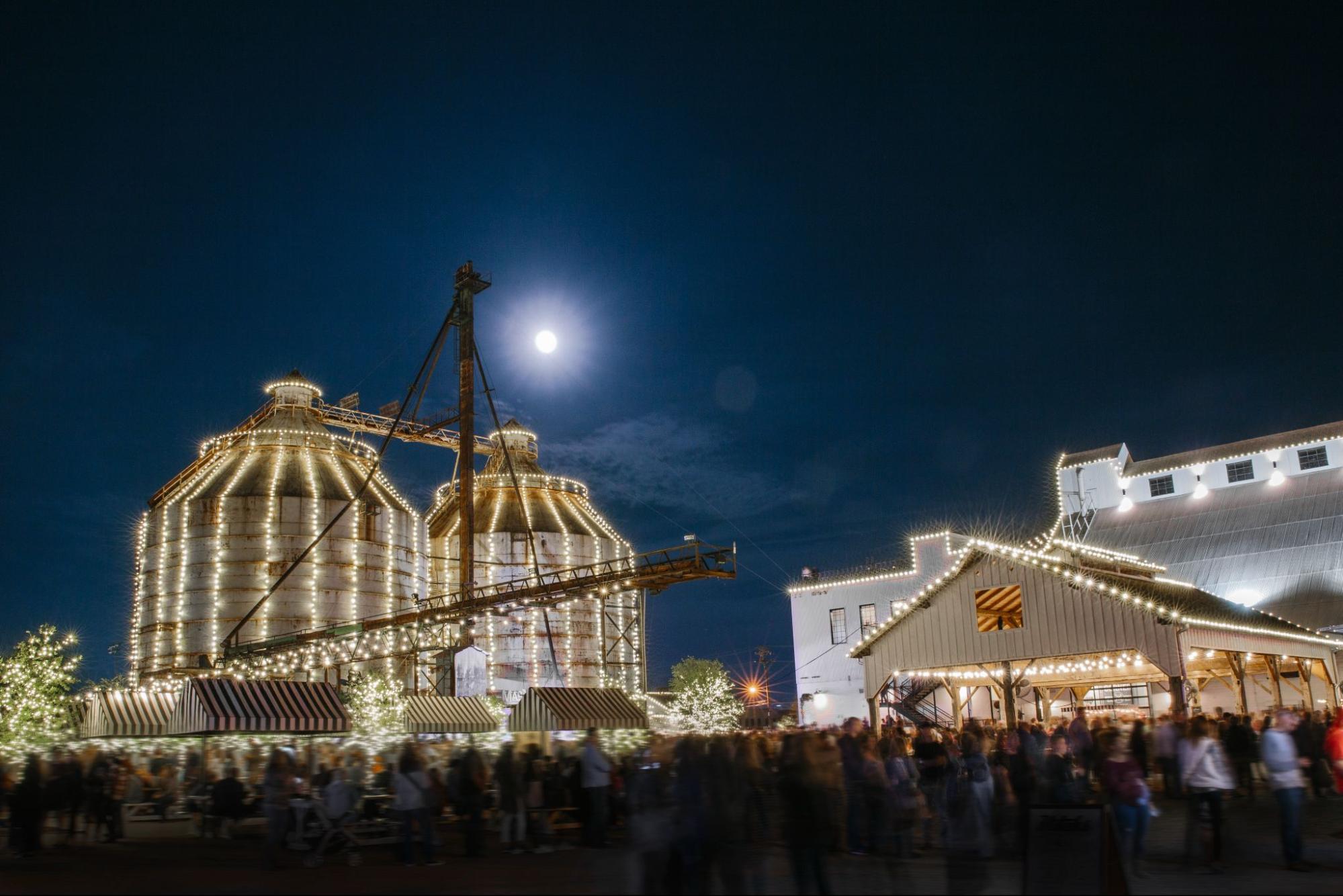 Magnolia Silos decorated with Christmas lights at night