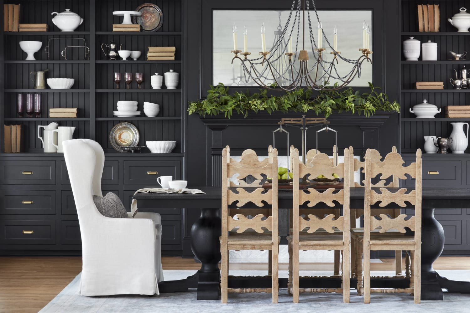 Black dining room with built-ins, fireplace, and a mix of dining chairs - Magnolia House in McGregor, TX.