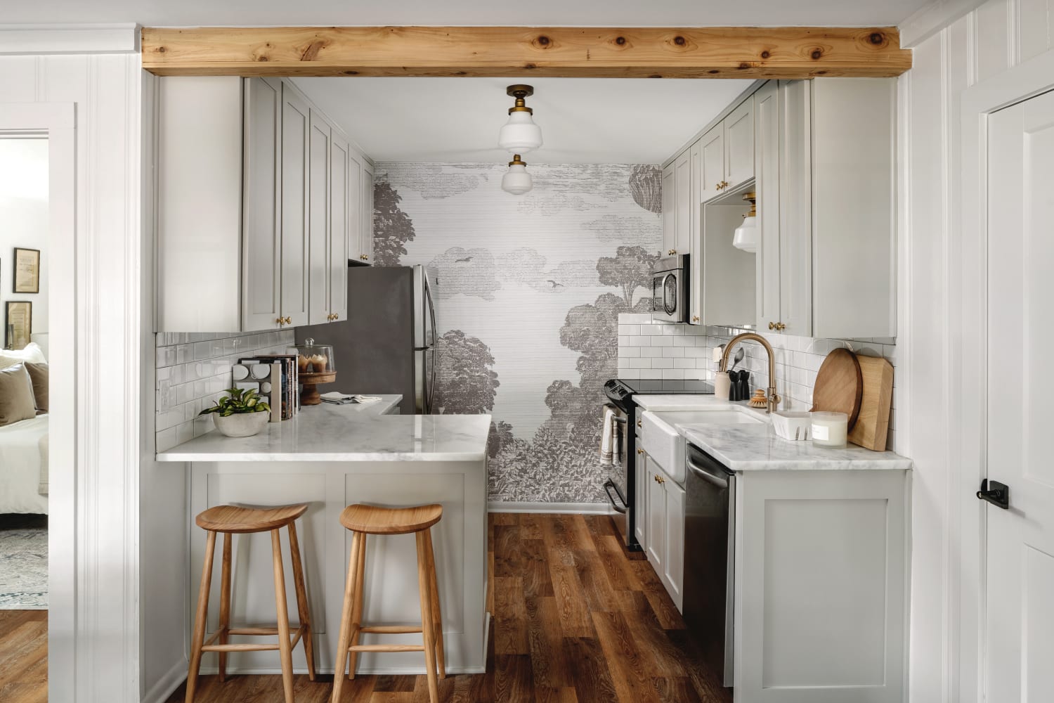 Gorgeous Joanna Gaines  kitchen with light grey cabinets and mural at Magnolia House in McGregor, TX.