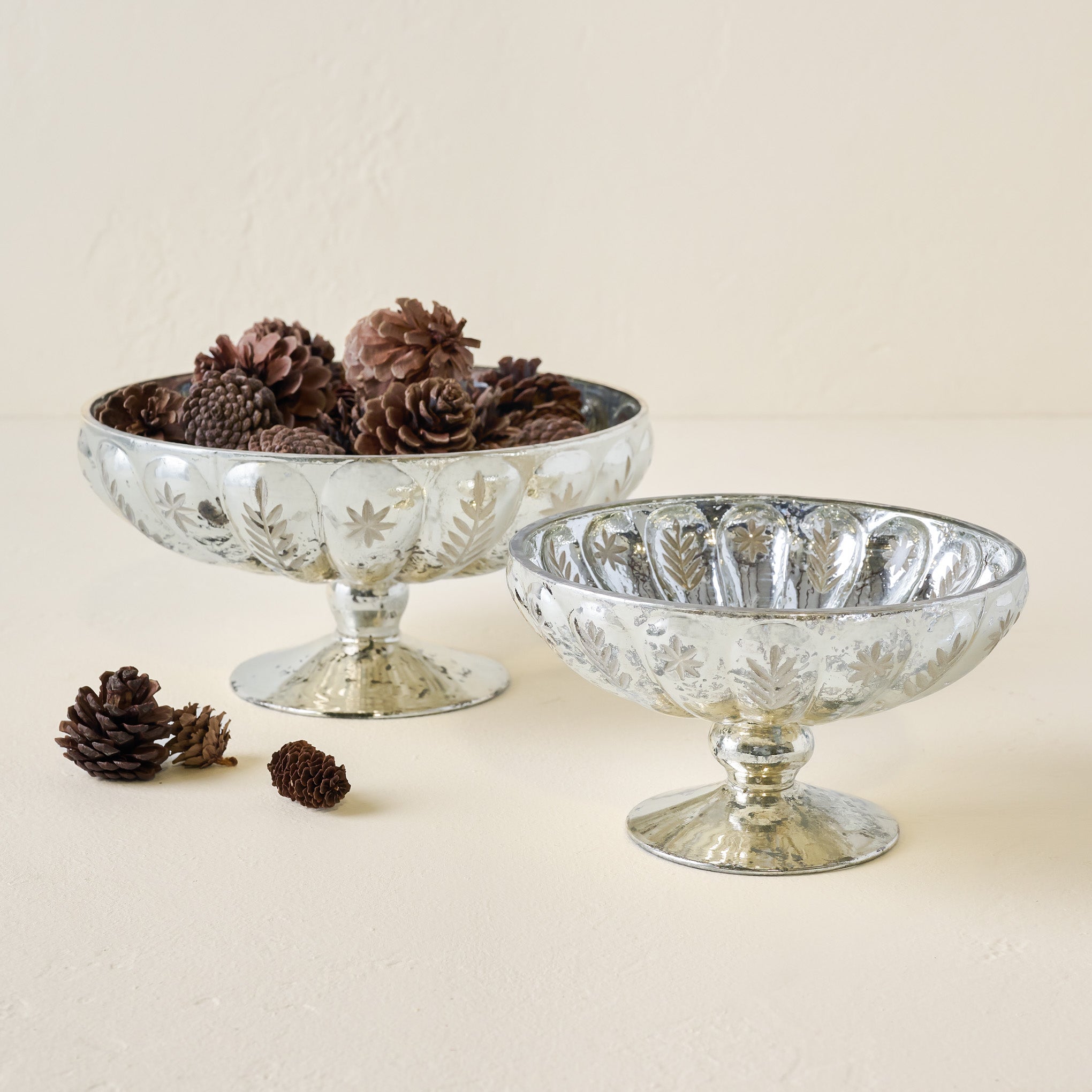 Small and LArge Etched Mercury Glass Compote Bowls shown  with pinecones On sale for $14.99, discounted from $32.00