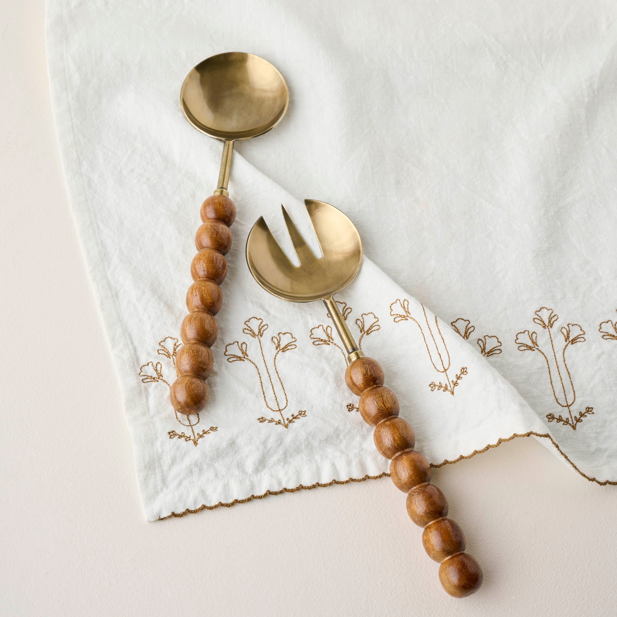 Antique Brass and Beaded Wood Serving Set shown on napkin $40.00