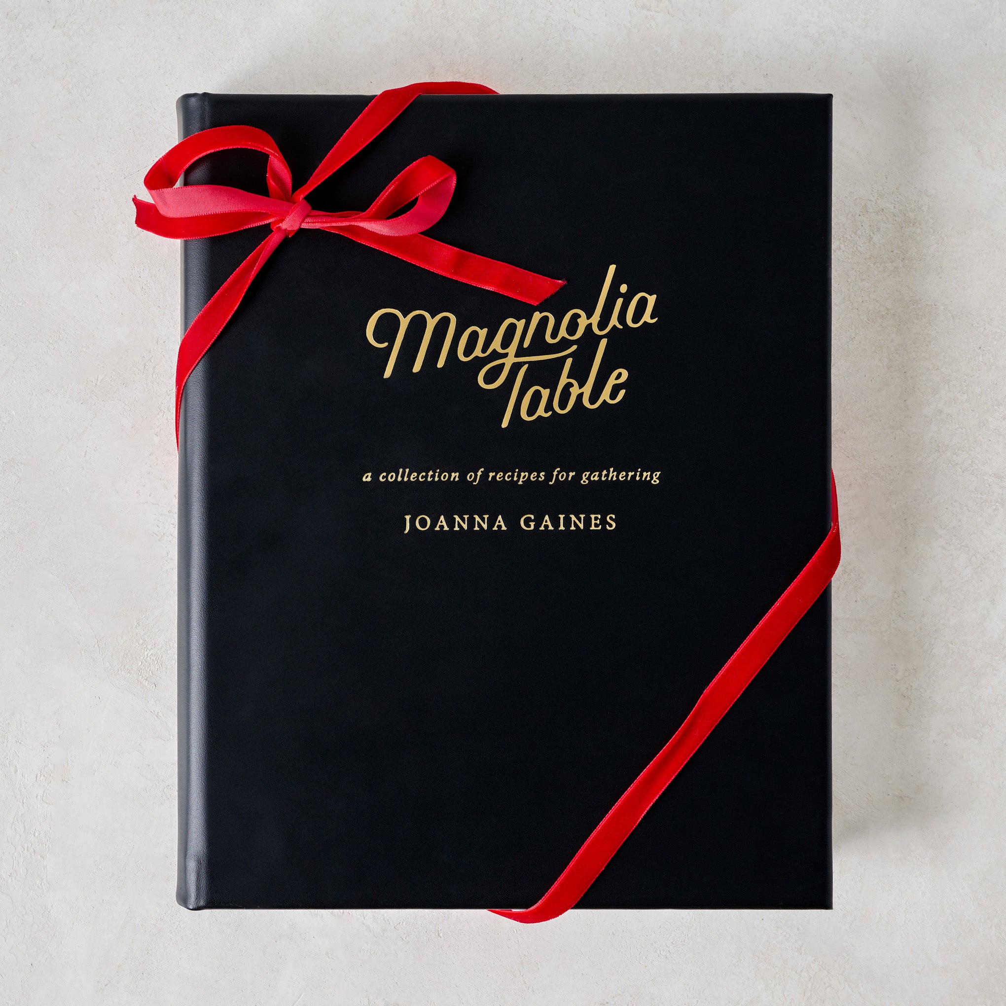 Leather Bound Magnolia Table Cookbook with ribbon around $135.00