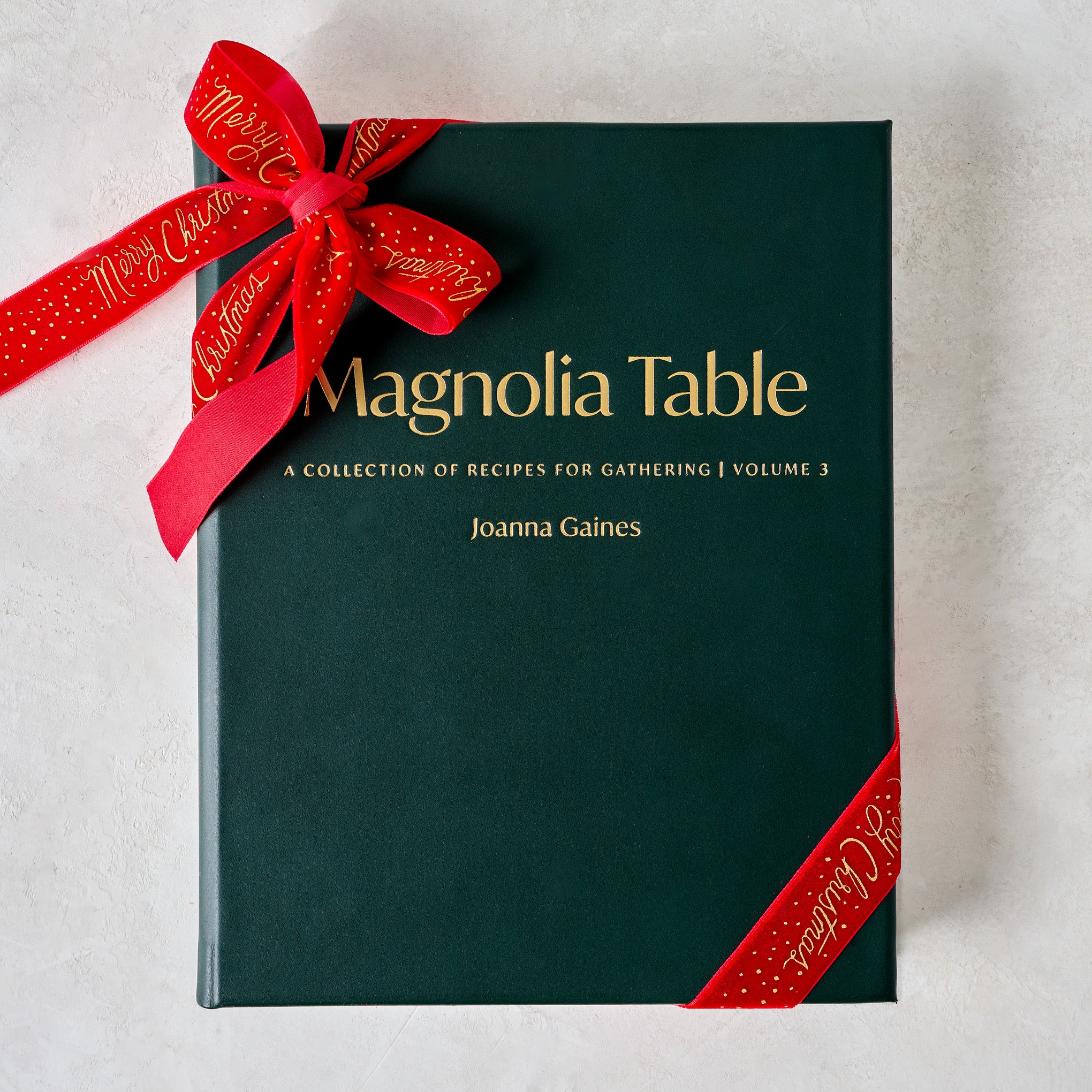 Leather Bound Magnolia Table Cookbook Volume 3 shown with ribbon $135.00