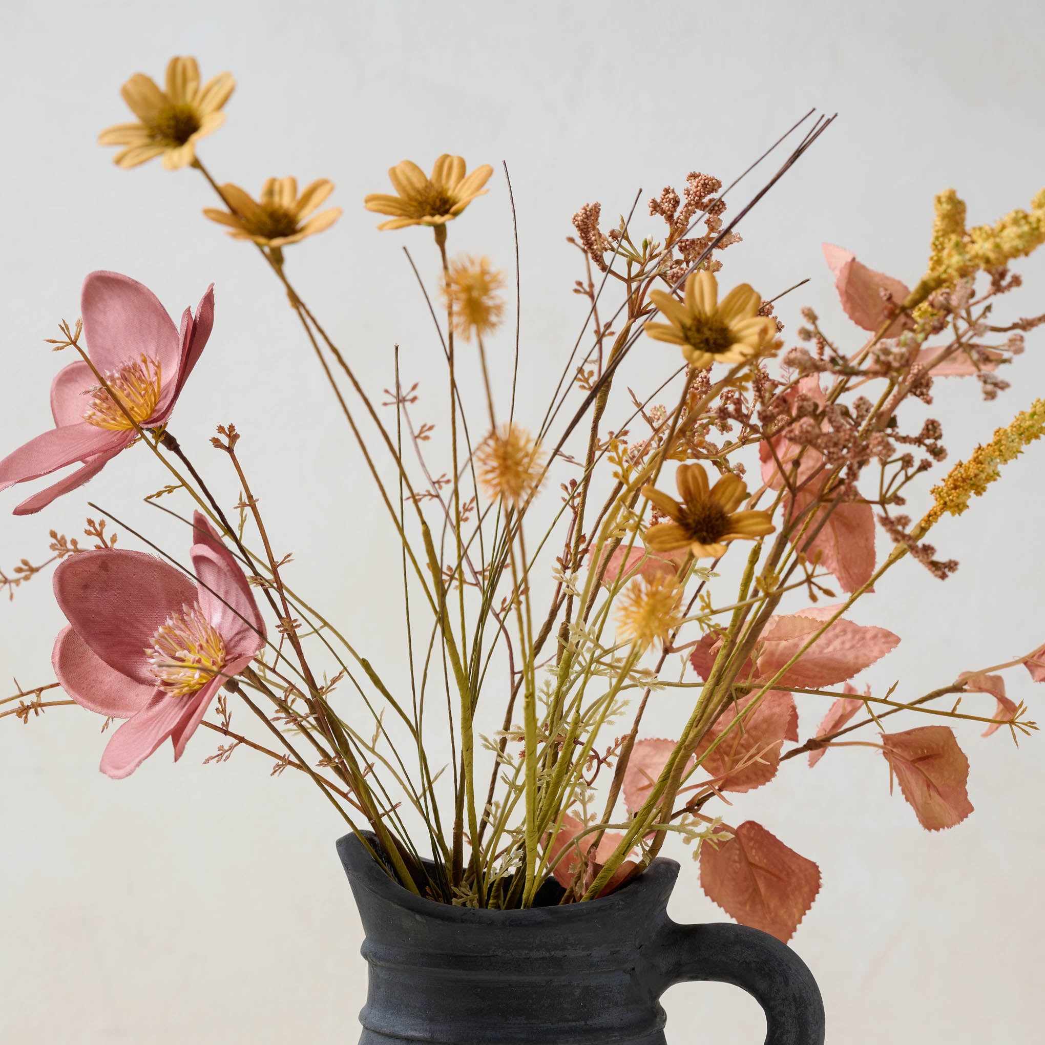 Harvest Bouquet bloom close up in black jug vase $16.00
