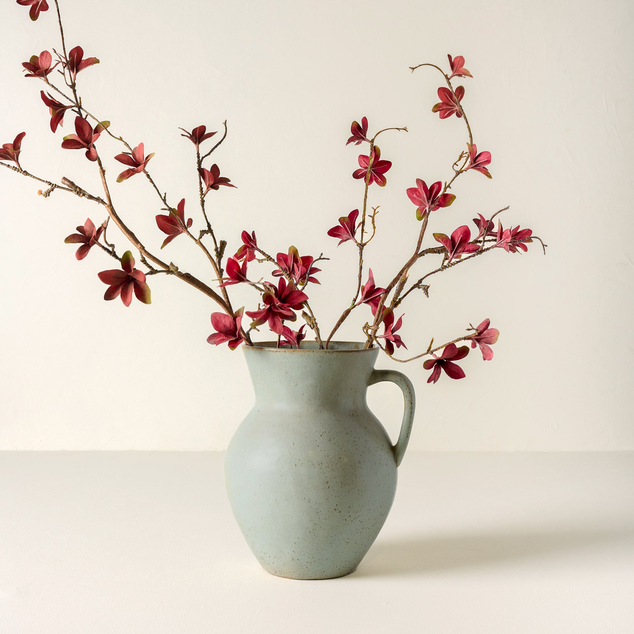 Large Magnolia Bloom Spray shown in green vase $14.00