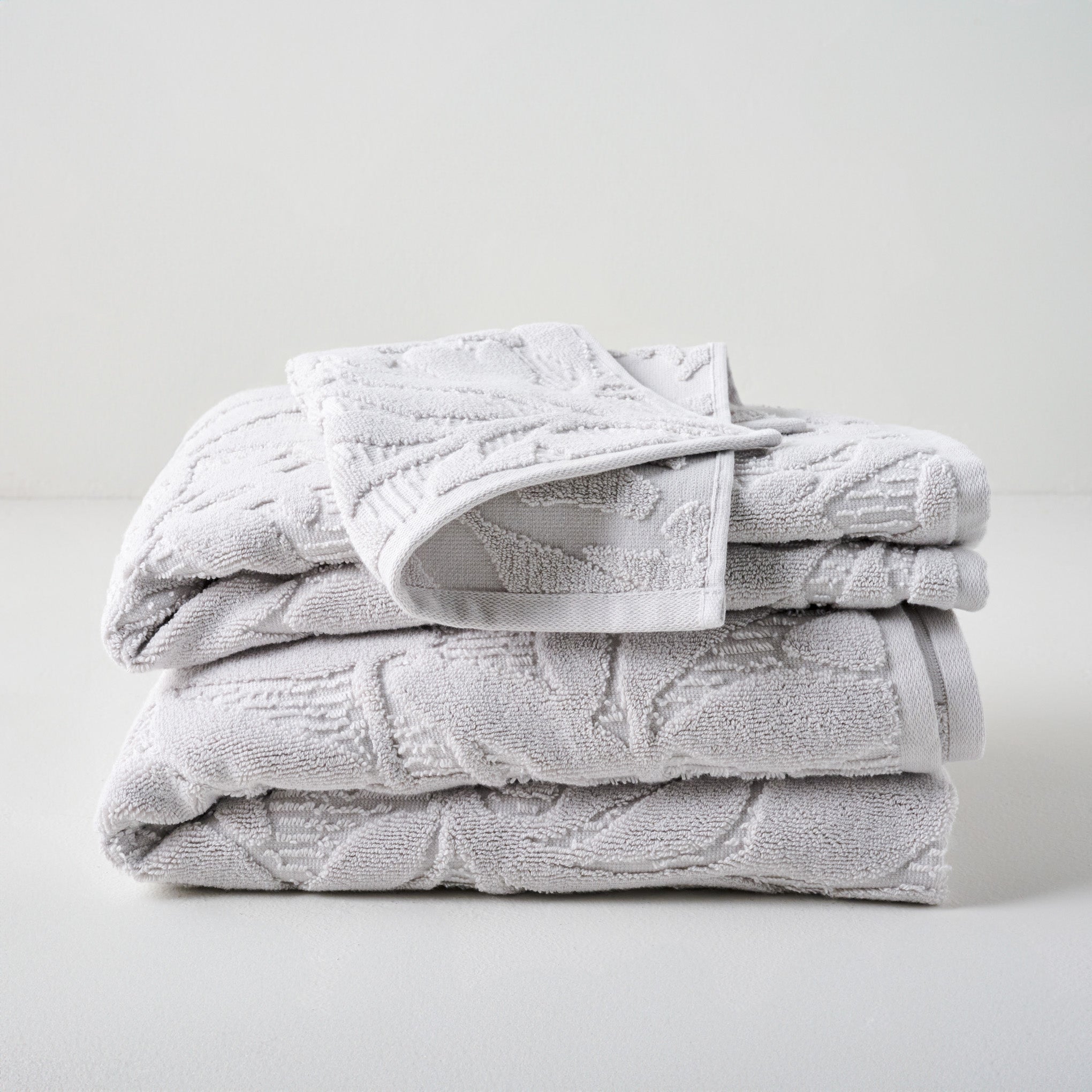 Platinum Esme Floral Towels shown stacked On sale with items ranging from $9.99 to $29.99, discounted from $12.00 to $34.00