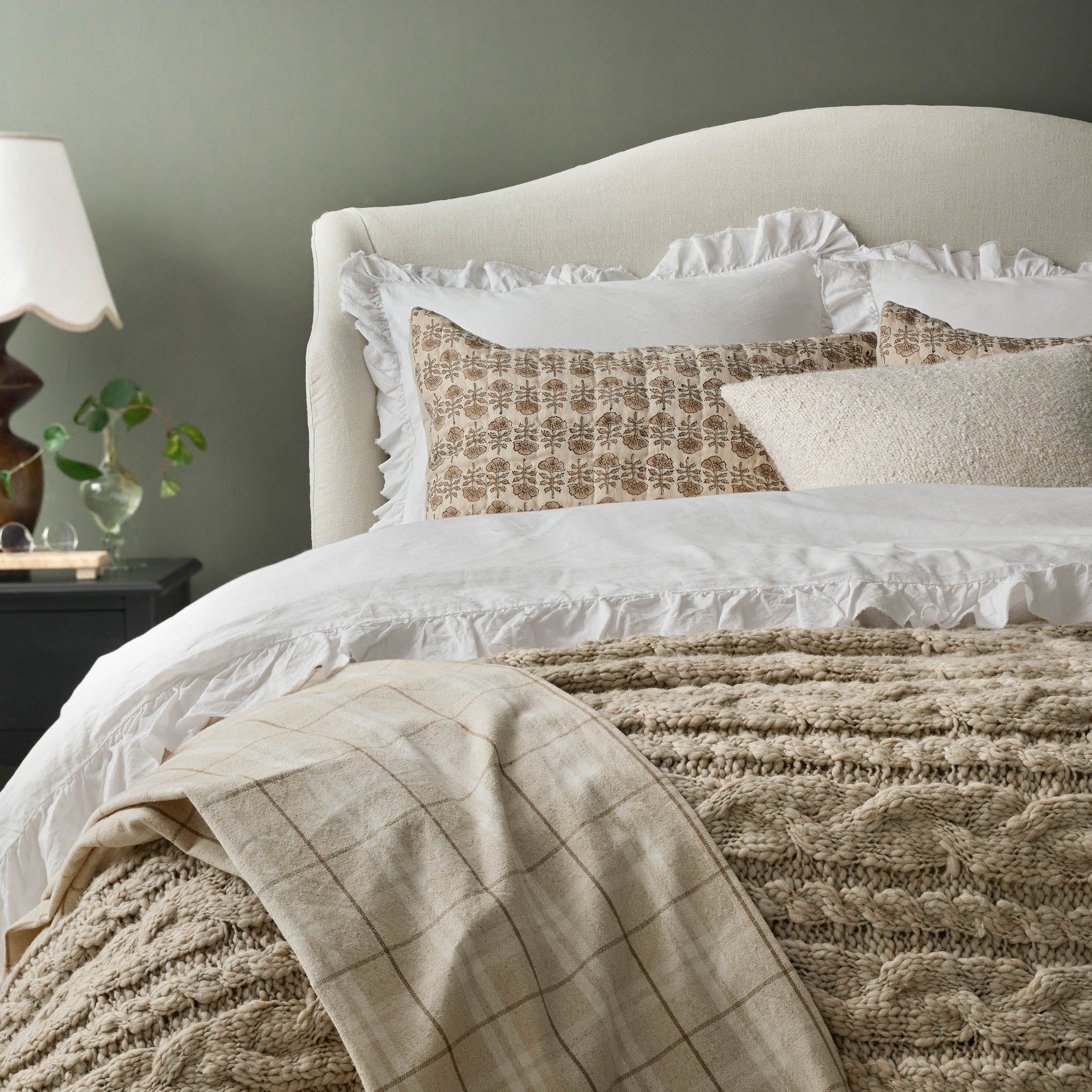 Optic White Ruffle Duvet Cover on a bed On sale with items ranging from $149.99 to $169.99, discounted from $180.00 to $200.00