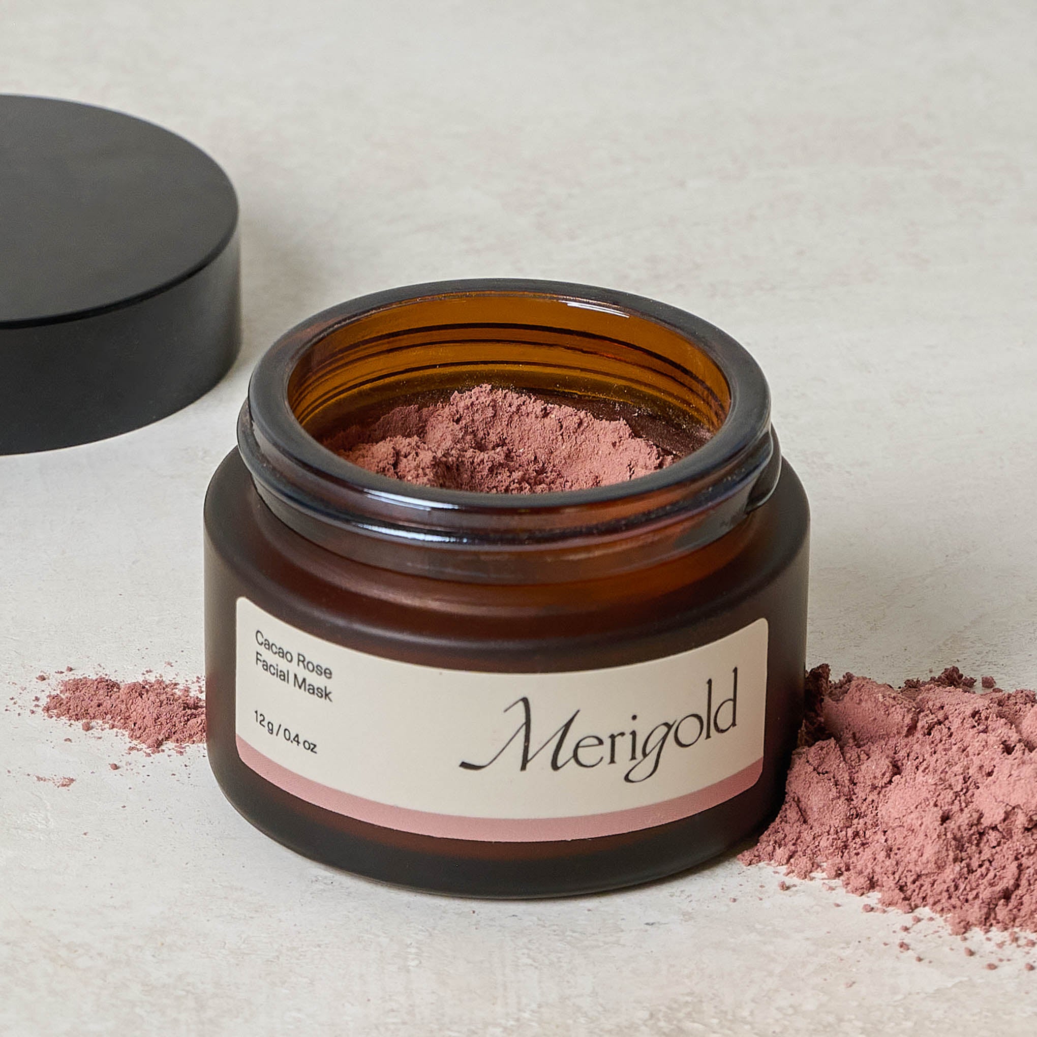 Merigold Cacao Rose Facial Mask jar with lid off next to powder $24.00