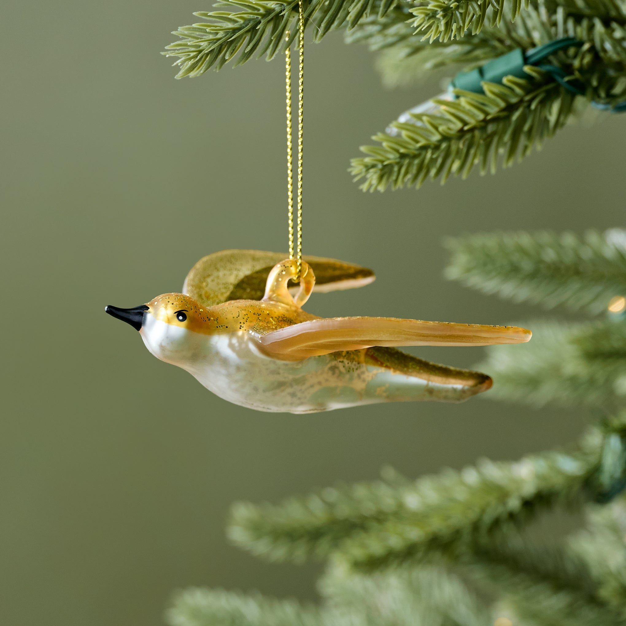 Gilded Swallow Glass Ornament shown on tree On sale for $9.99, discounted from $20.00