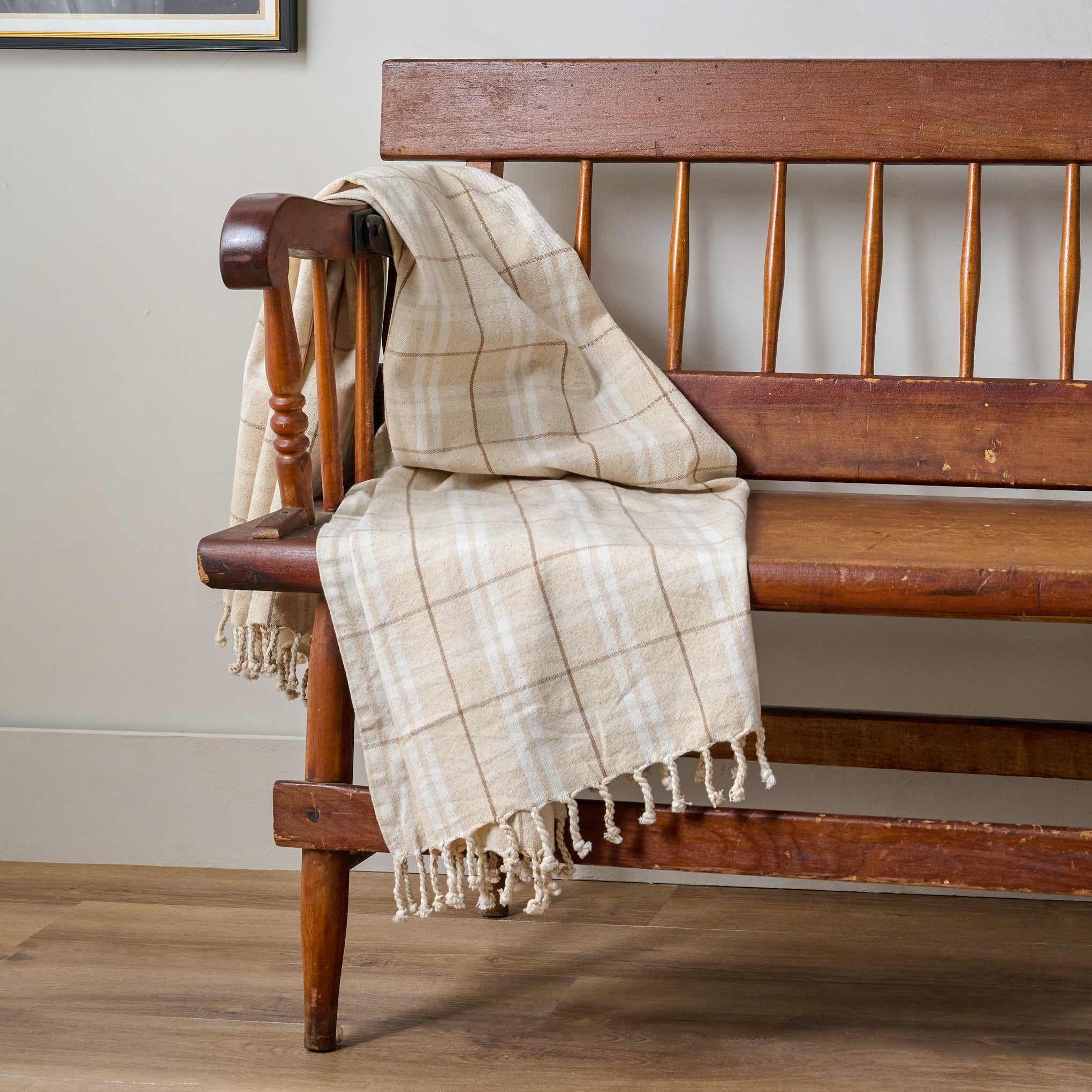 Turtledove Harmony Throw shown draped over wooden bench