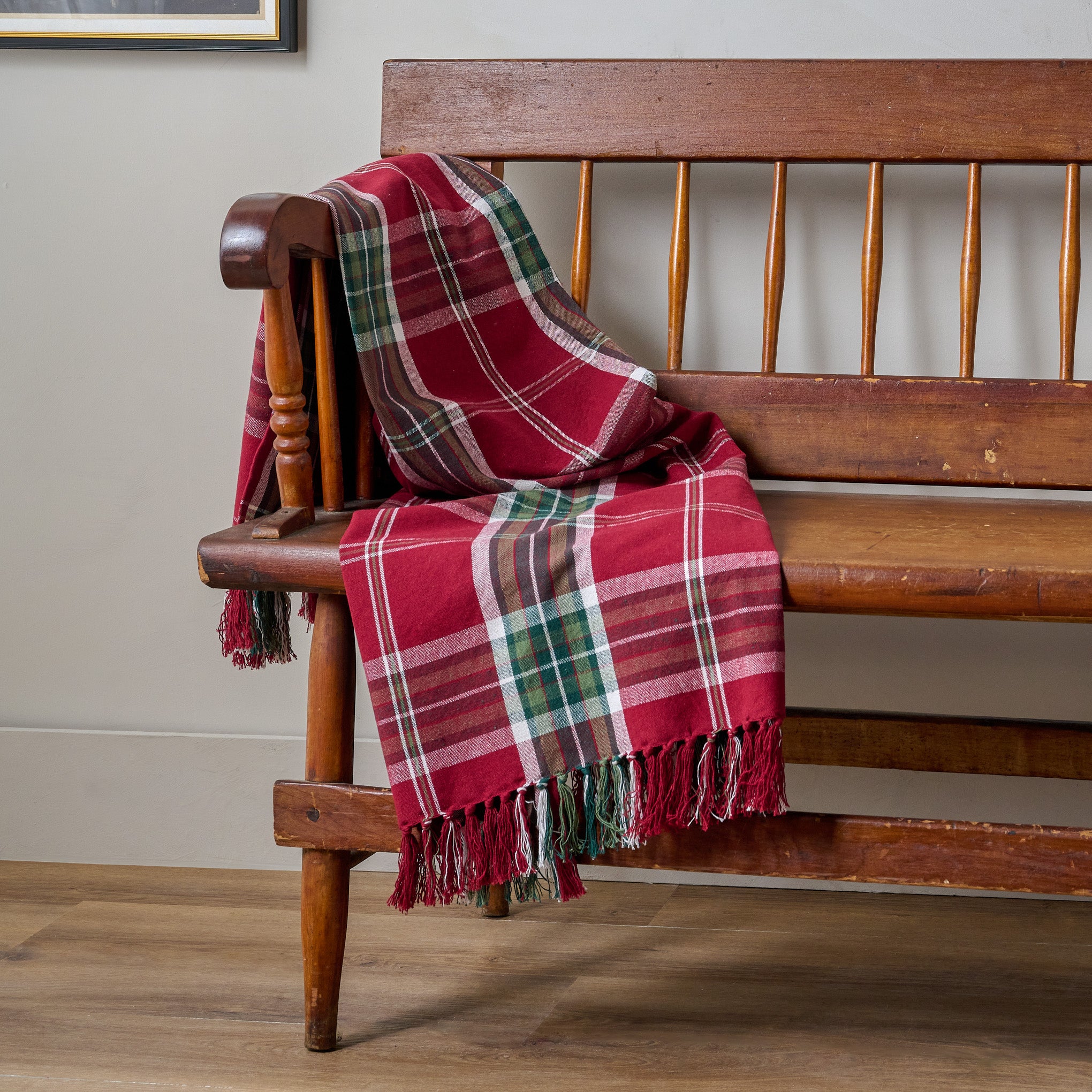 Joyful Harmony Throw shown draped over wooden bench