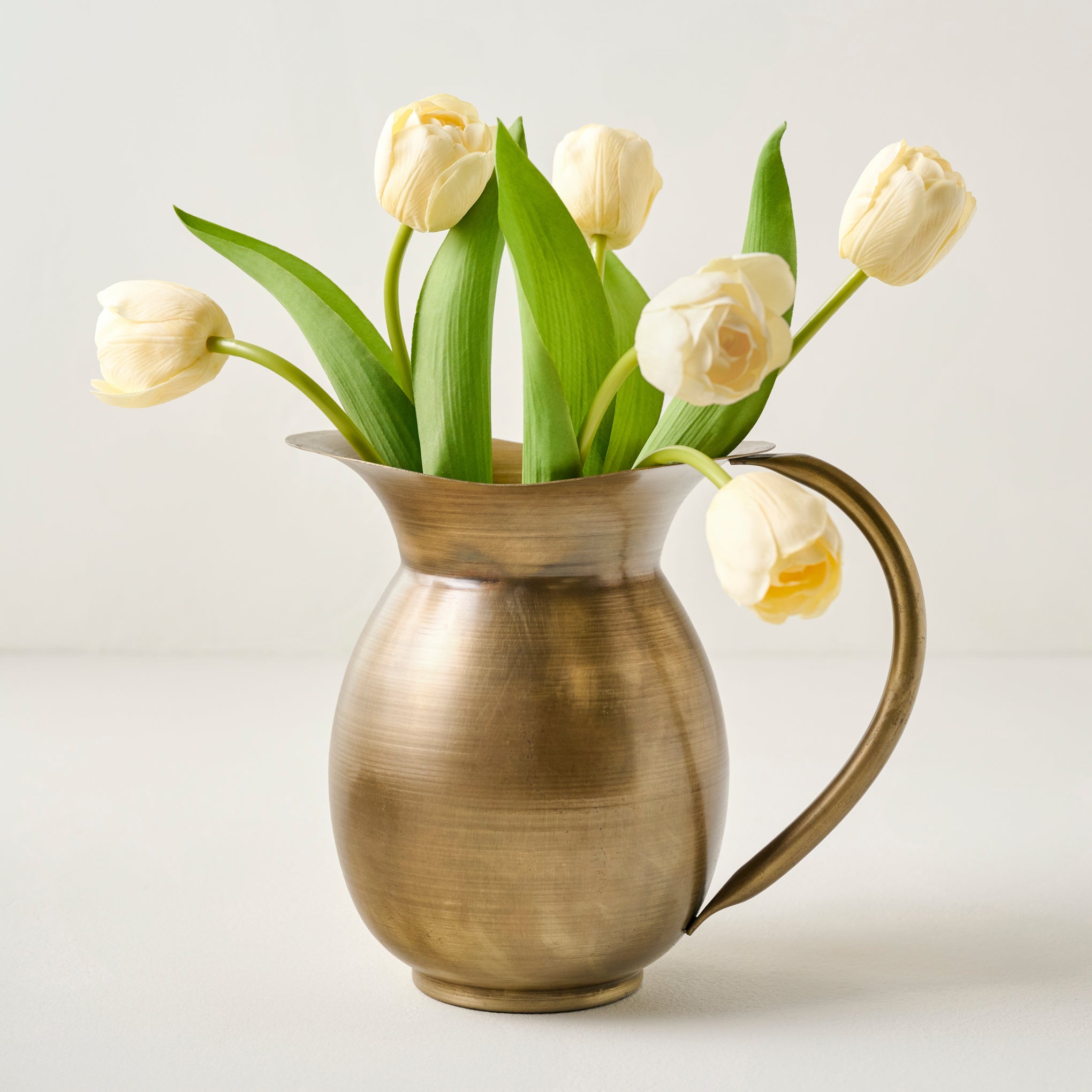 Ruthie Brass Pitcher Vase shown with florals