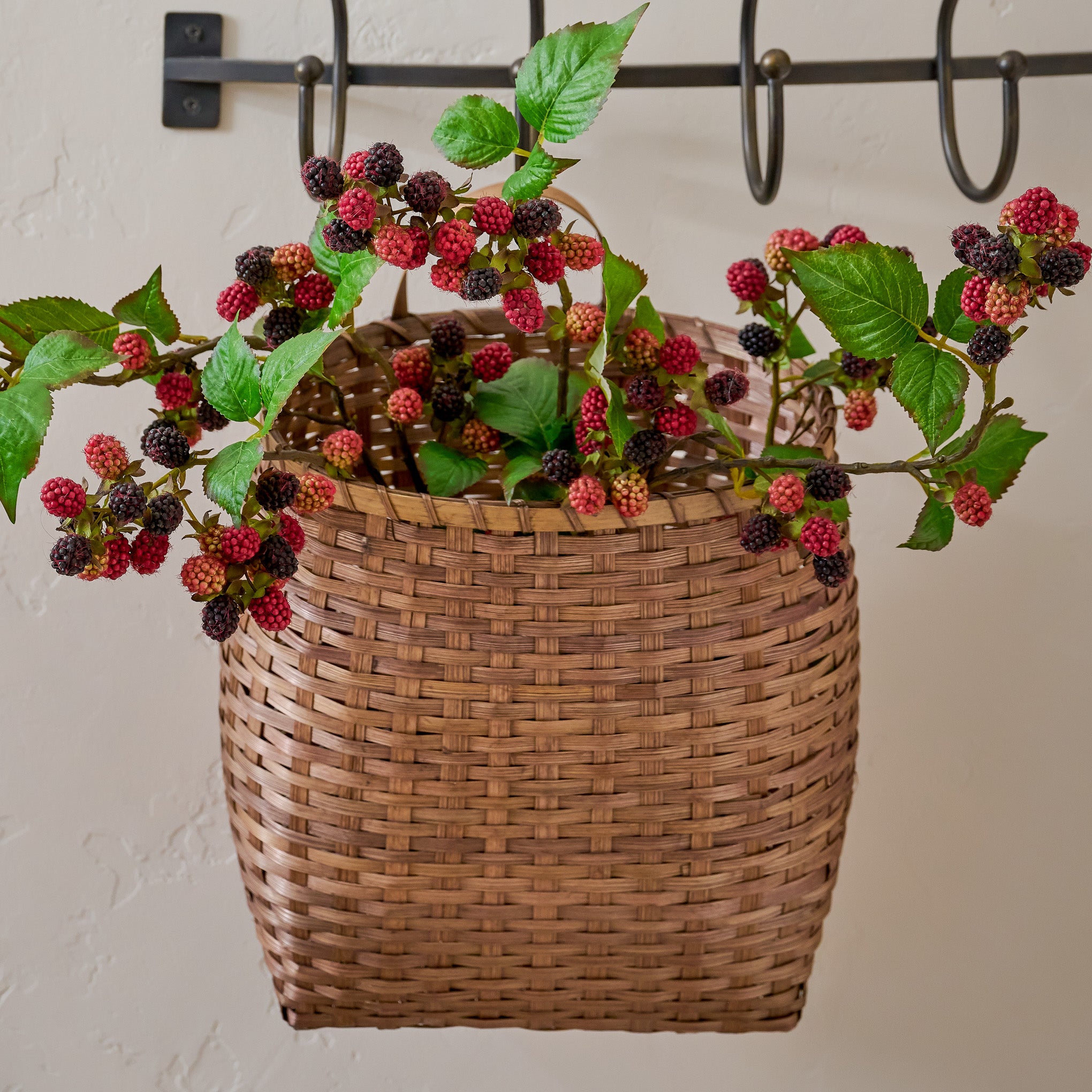 Turner Woven Wall Basket shown styled with seasonal stems $38.00