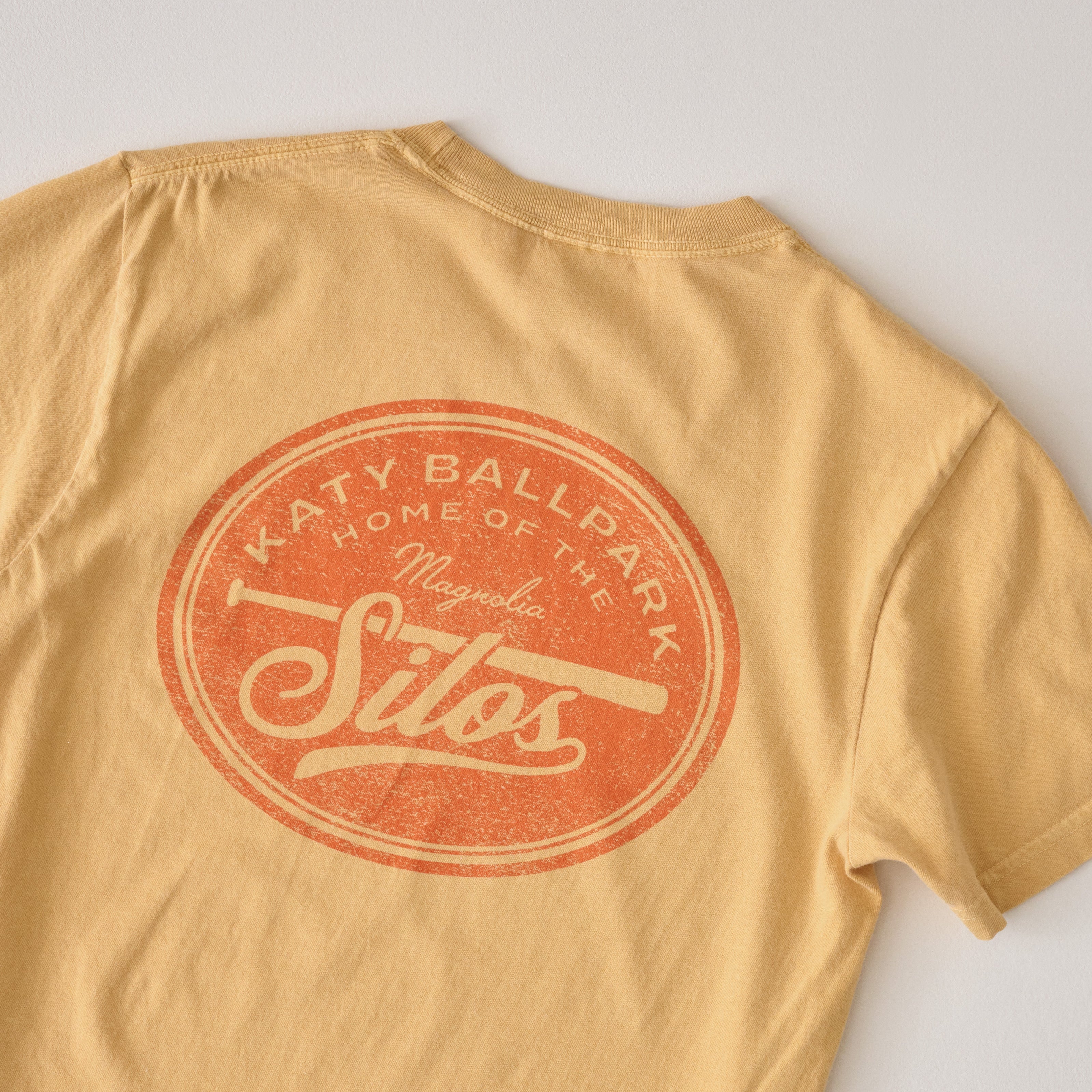 back of Katy Ballpark Mustard Crest Tee