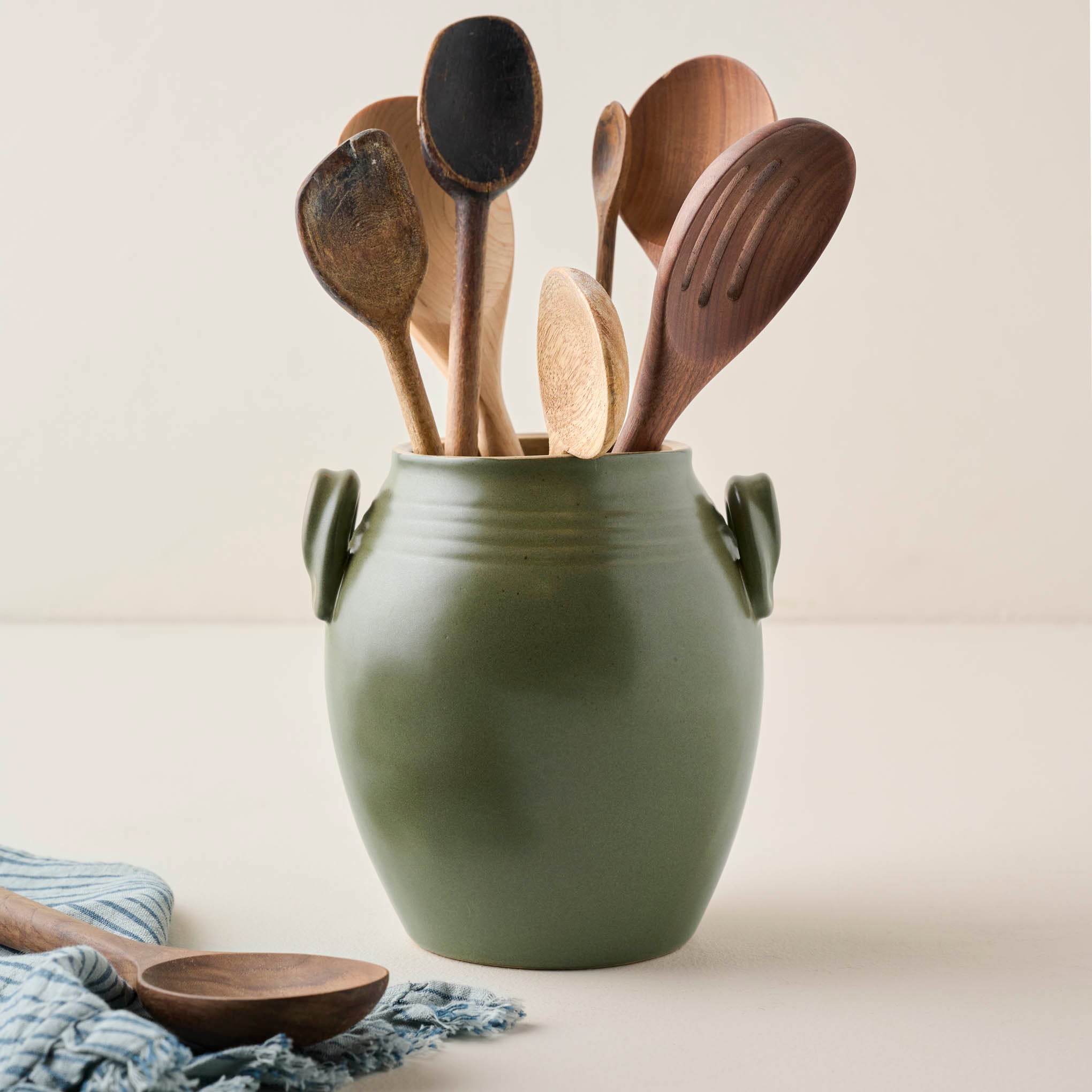 Vintage-Inspired Sage Green Utensil Crock shown filled with wooden spoons