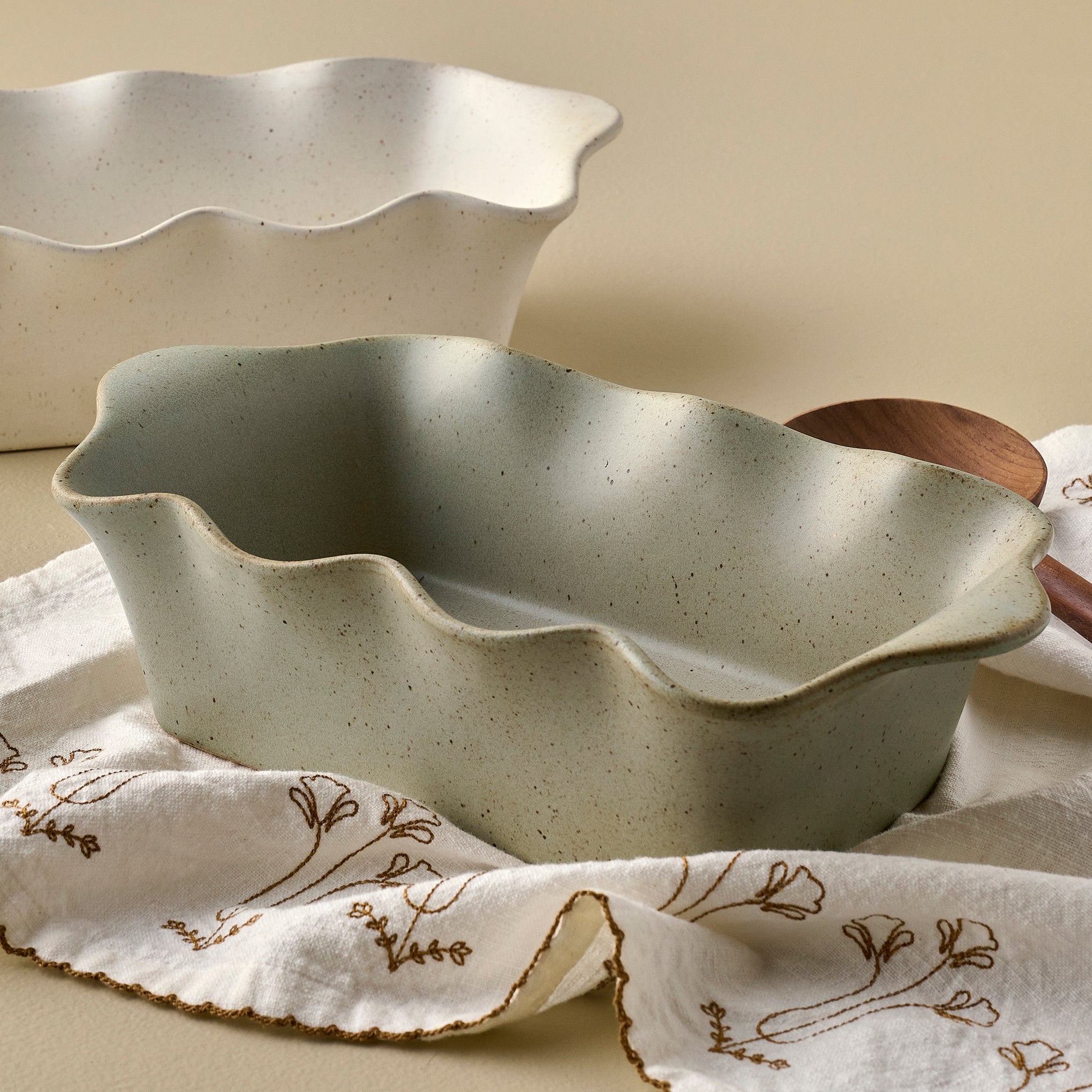 Loden Green Scalloped Loaf Pan shown with tea towel and serveware $40.00