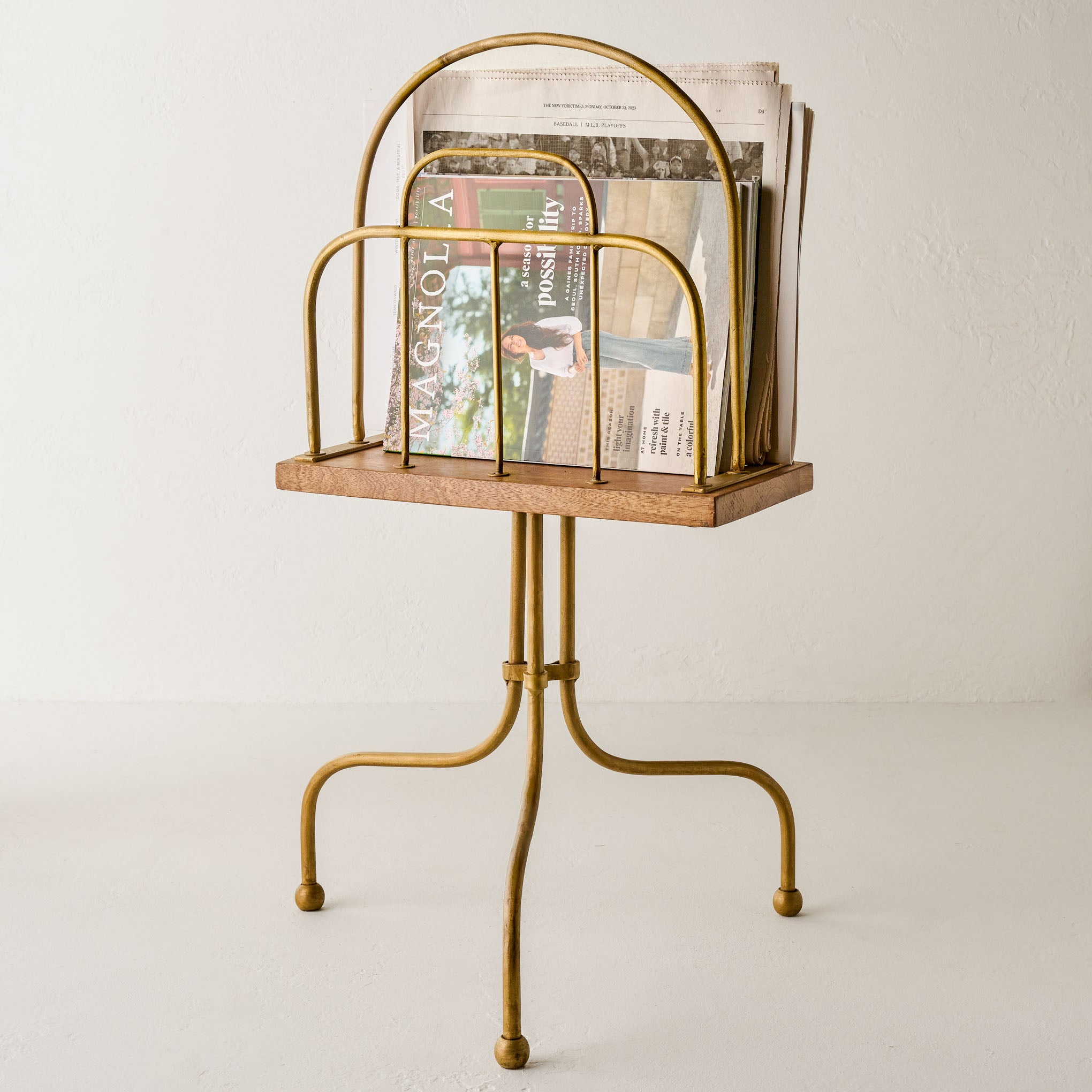 Antique Brass and Wood Media Stand shown holding magazines