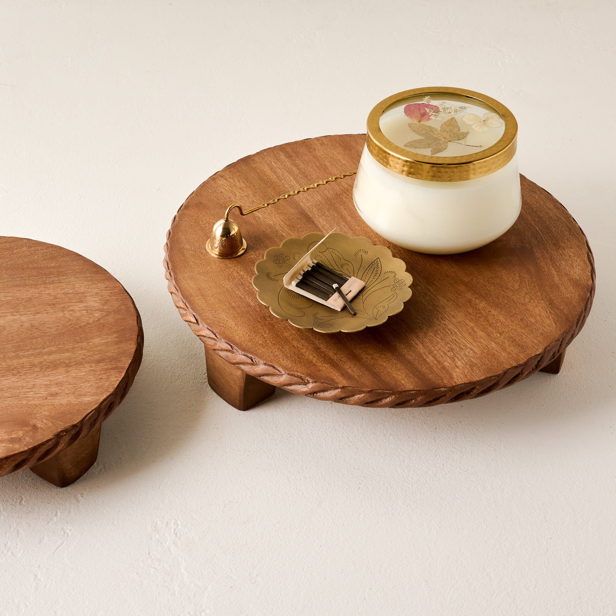 Small and Large Carved Rope Footed Risers shown with candle and trinkets