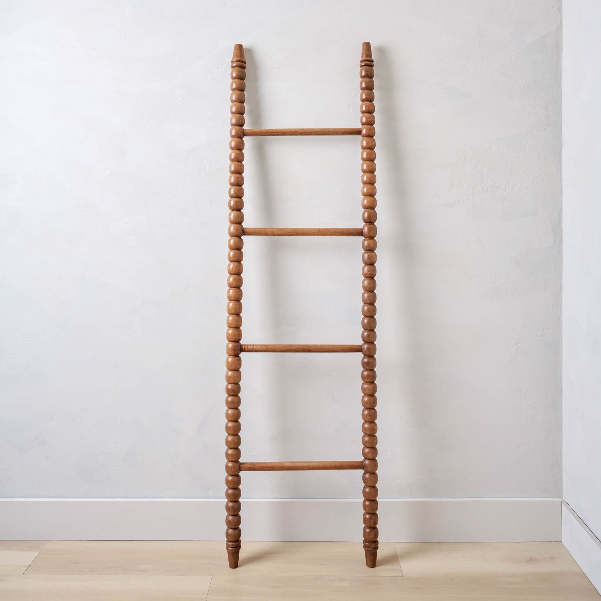 sylvie spindle ladder leaning against a wall