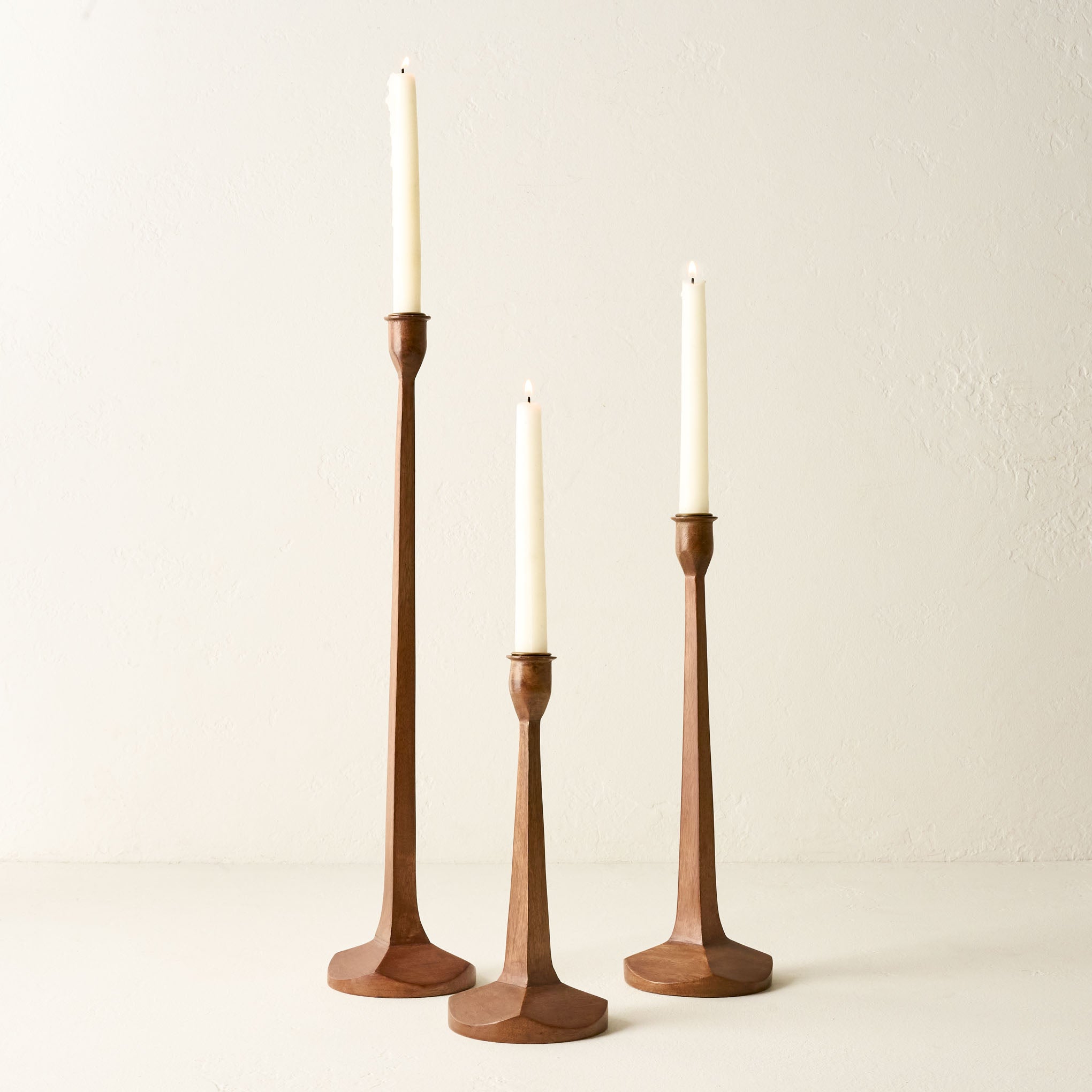 Short, Medium, and Tall Wooden Gatecrests shown holding candles