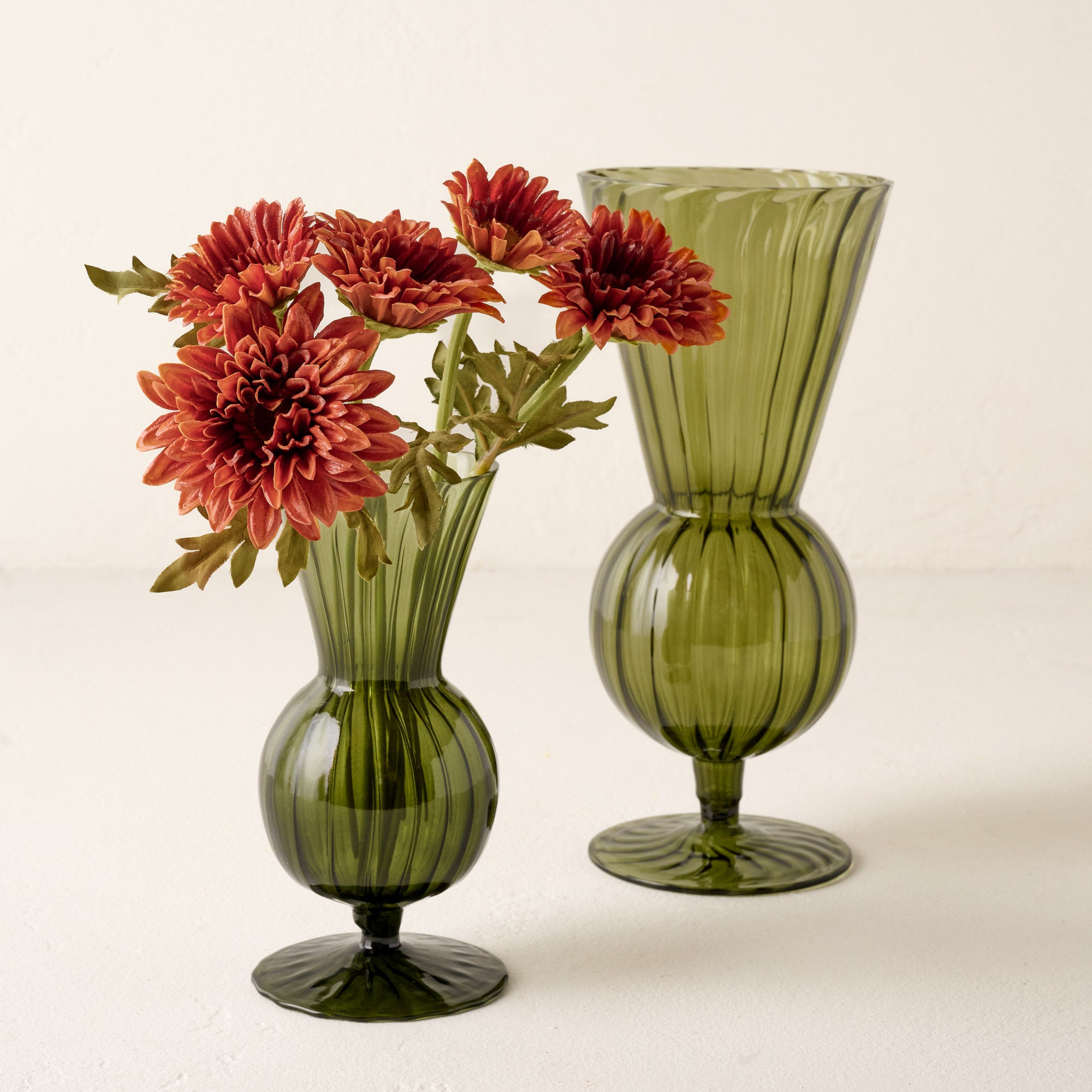 Small and Large Fluted Green Glass Vase shown holding flowers Items range from $20.00 to $26.00