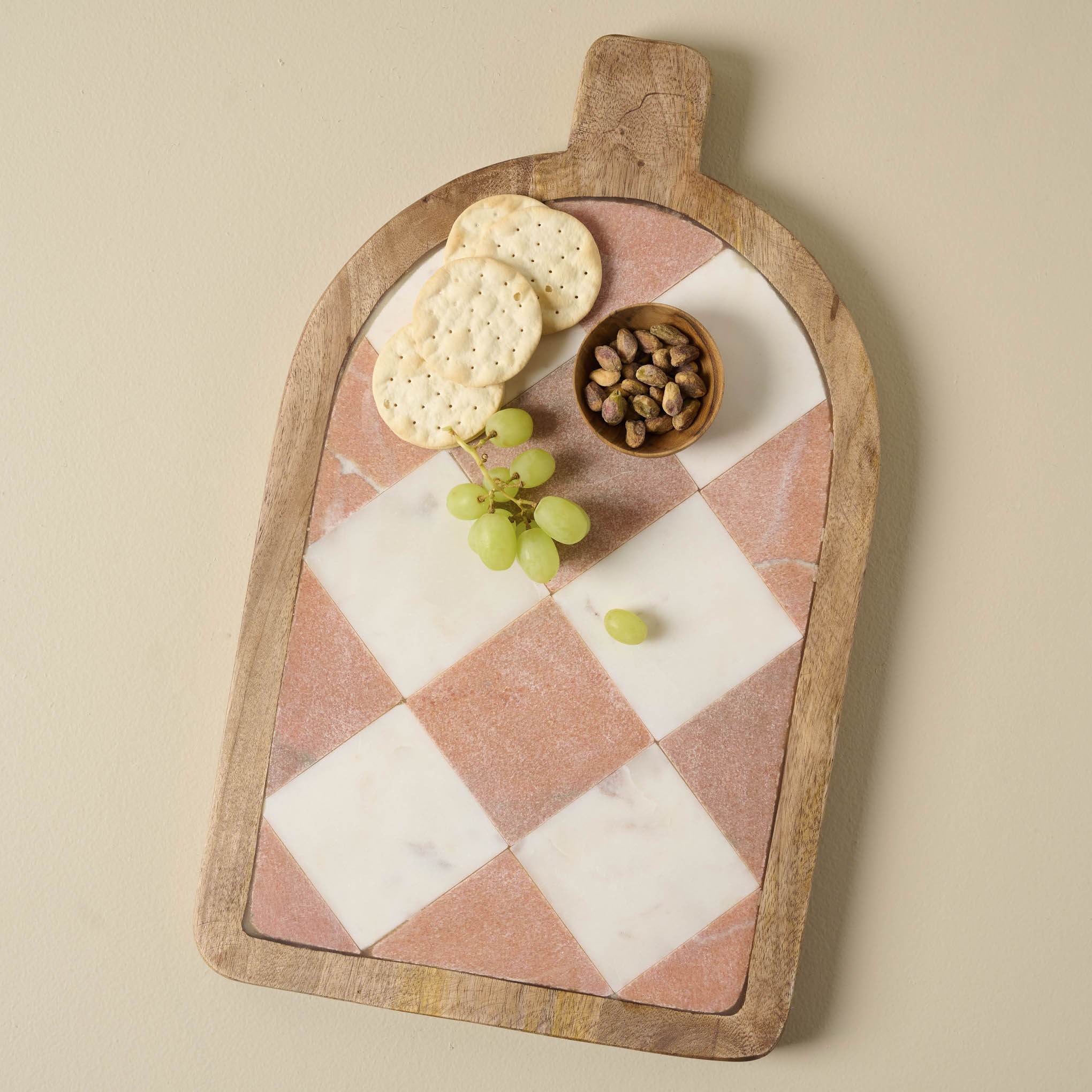 Carmella Checkered Marble Serving Board with nutes, grapes, and crackers on top $72.00