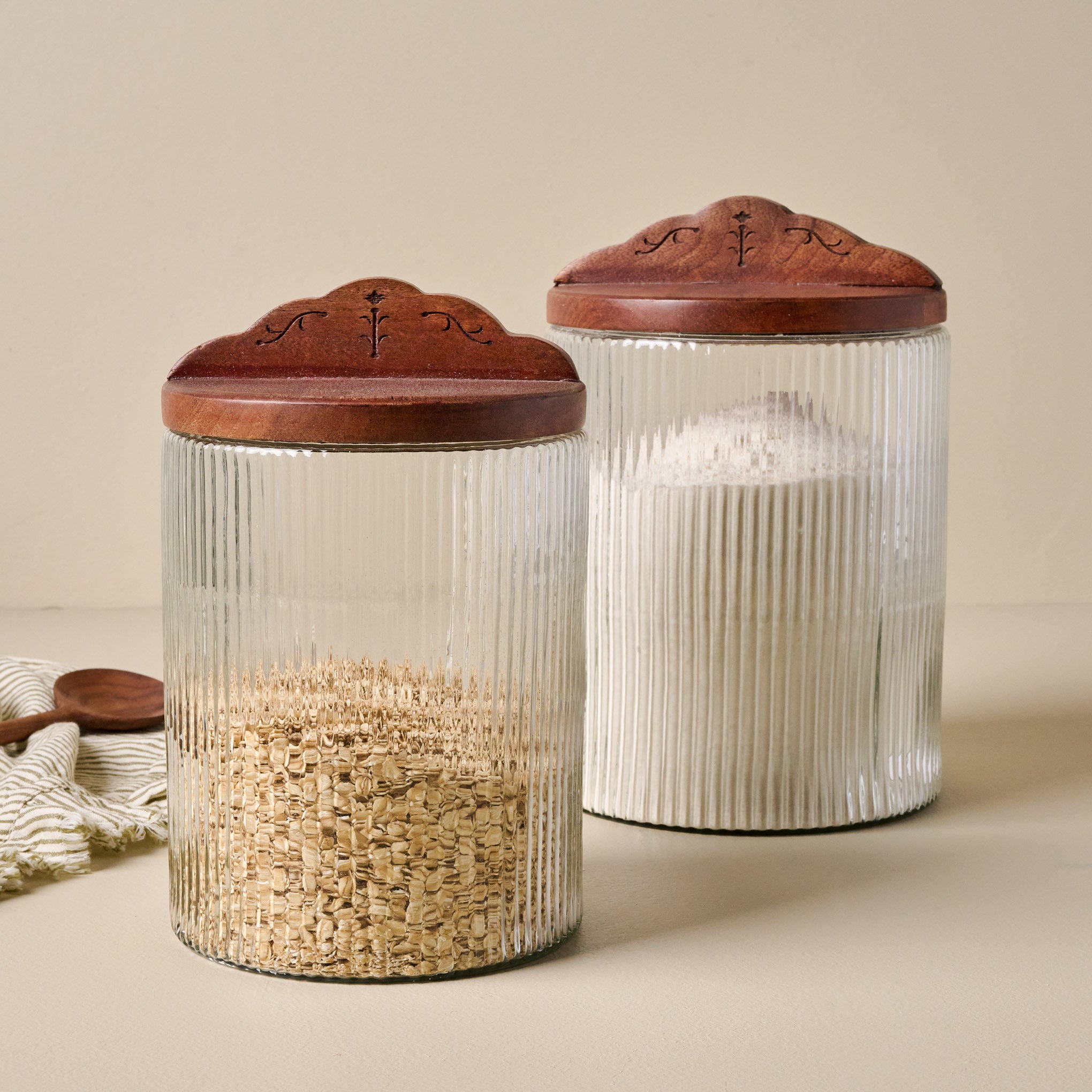 Small and Large Antiqued Wood Ribbed Glass Canisters filled with oats  and flour Items range from $38.00 to $44.00