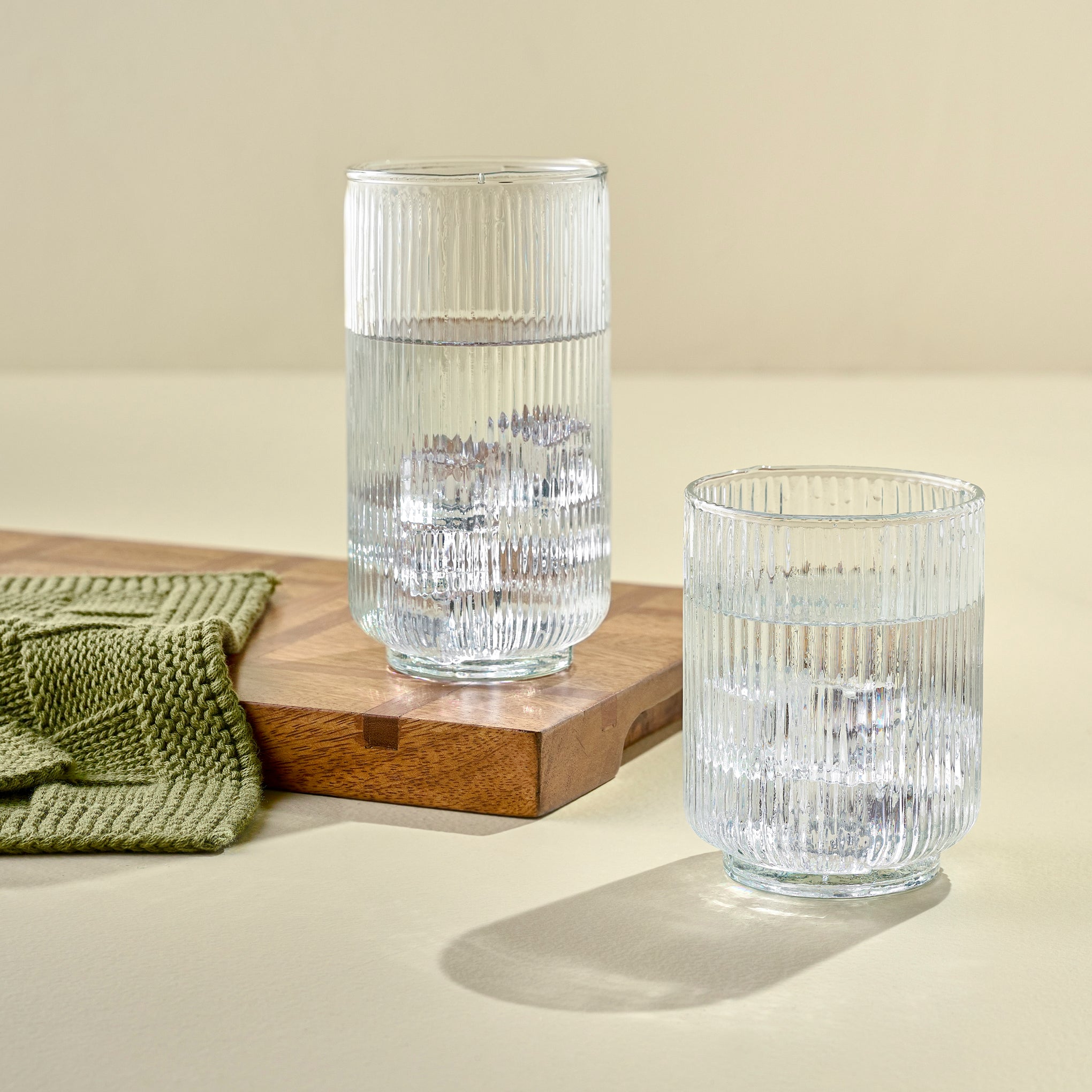 Short and Tall Atlas Ribbed Glass Tumblers shown filled with water  Items range from $12.00 to $14.00