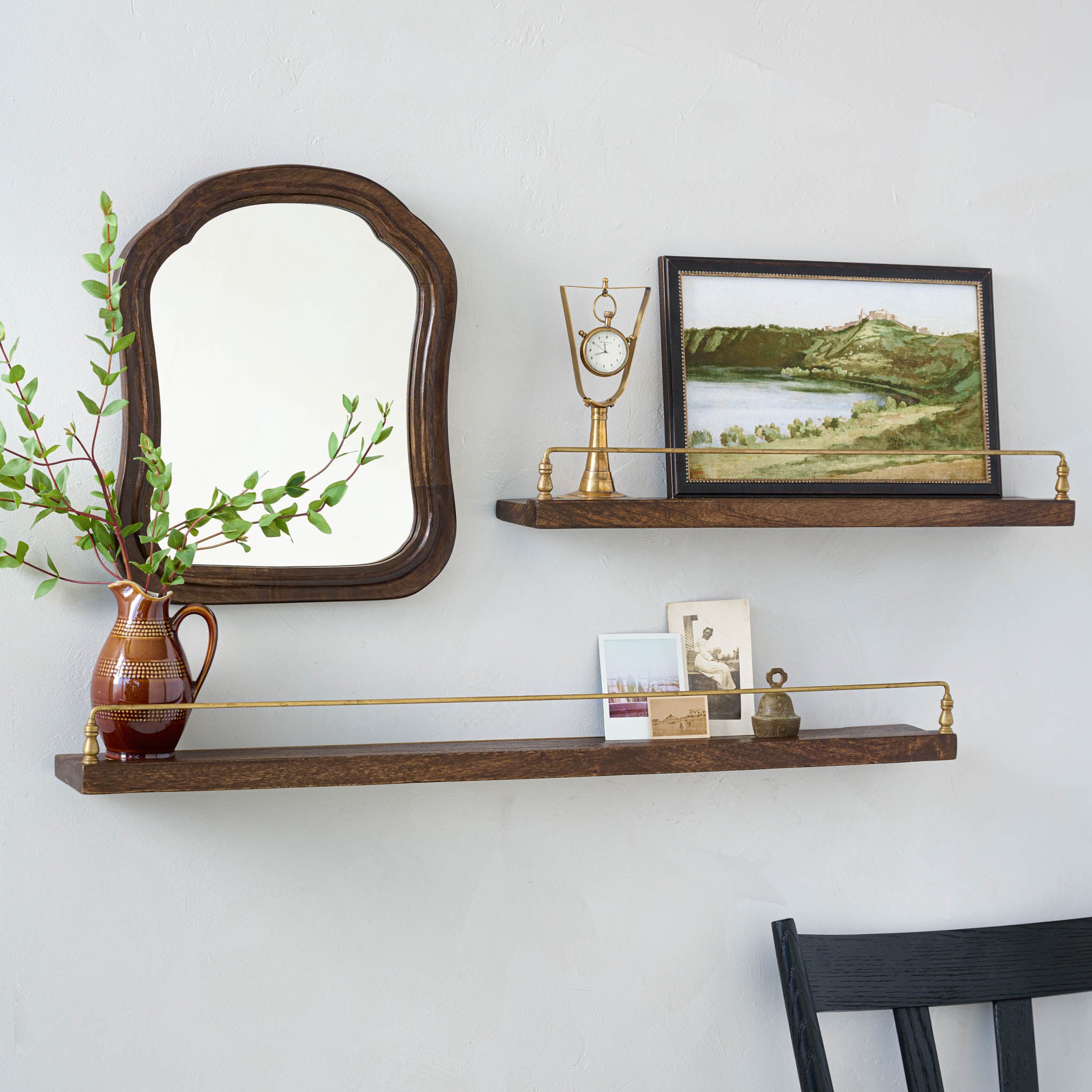 Elliott Wood and Brass Picture Ledge in both sizes hung on a wall with decor on top Items range from $38.00 to $48.00