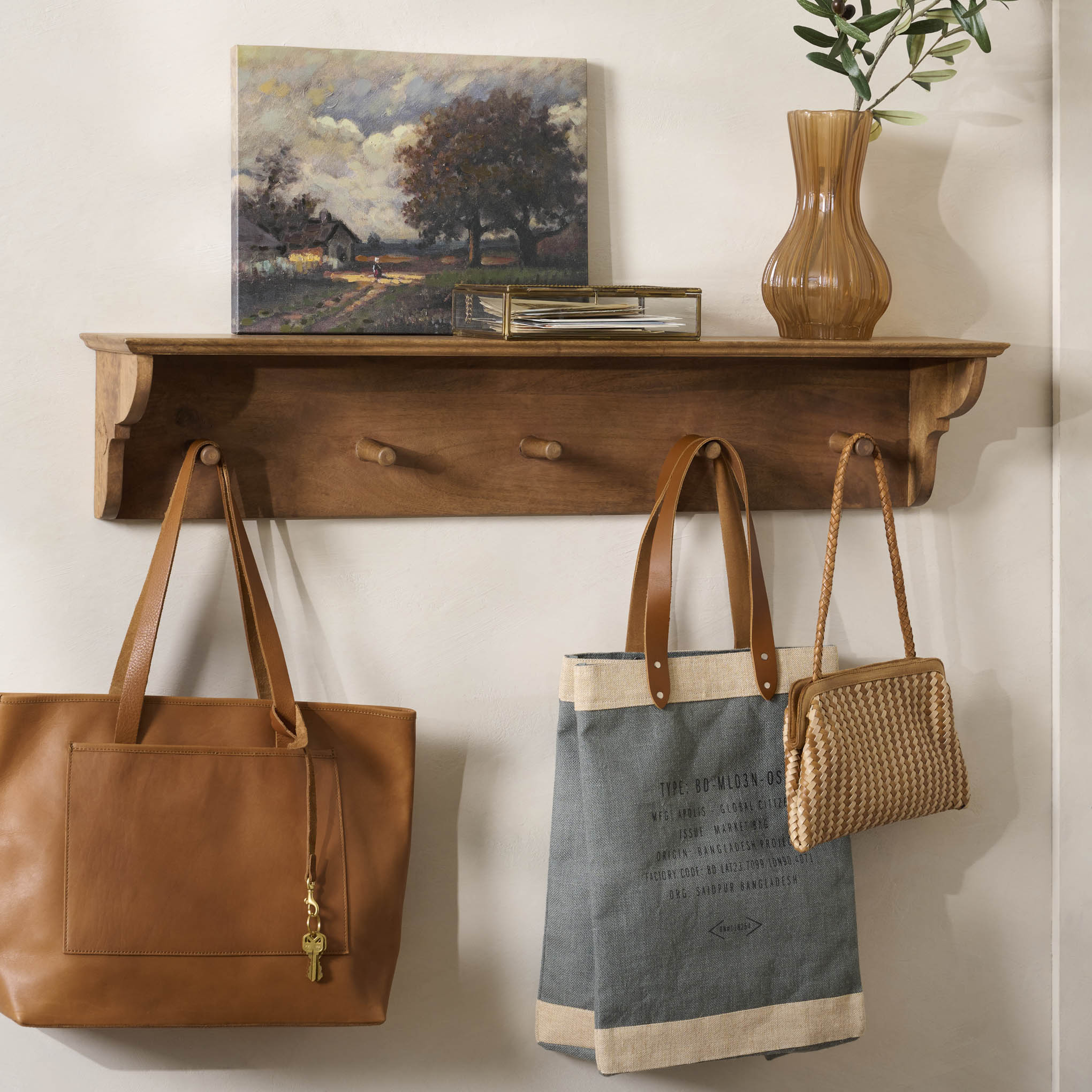 Dorothy Antiqued Wood Shelf with Pegs shown with bags hung 