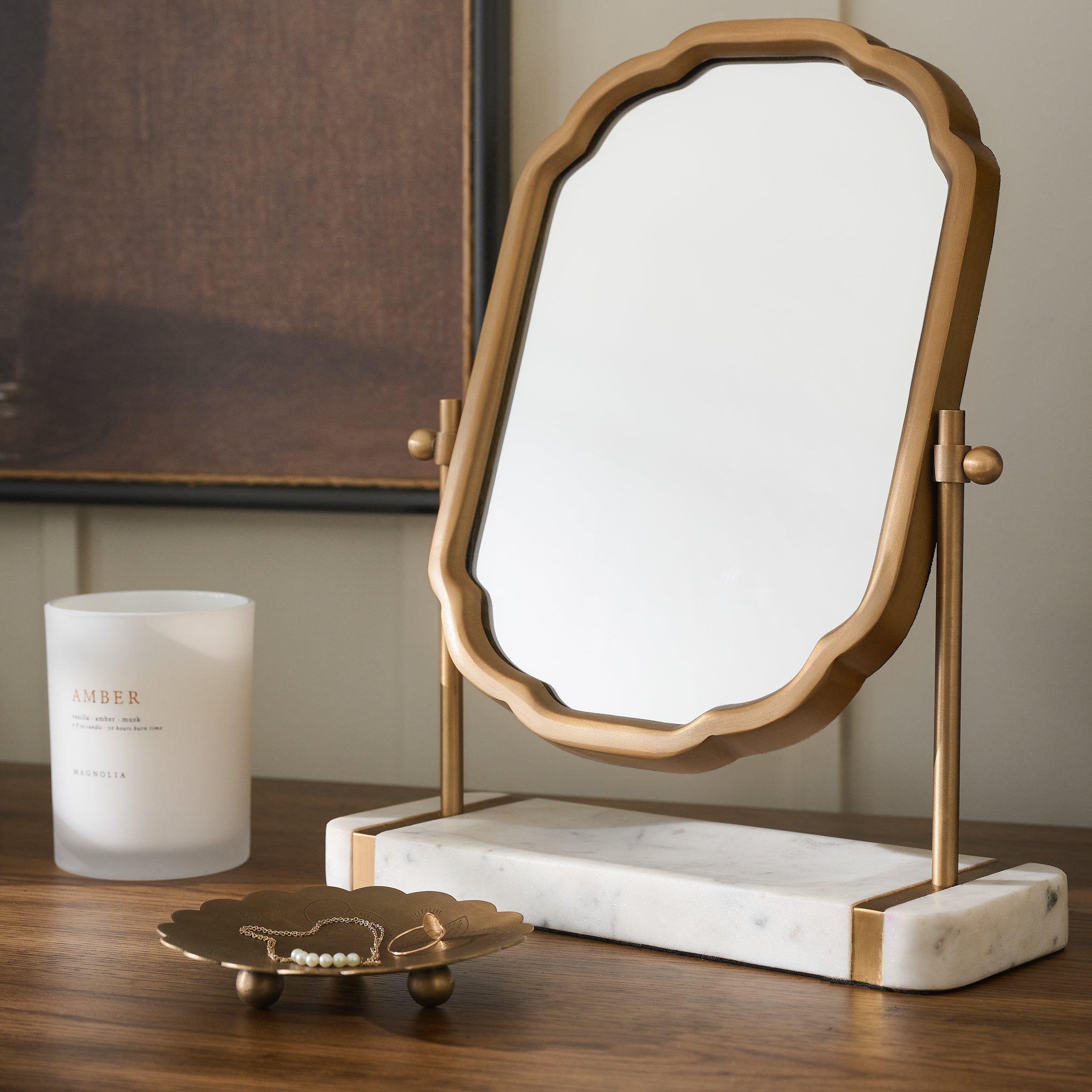 Antique Brass and Marble Vanity Mirror shown with candle and trinket tray on wood table $68.00