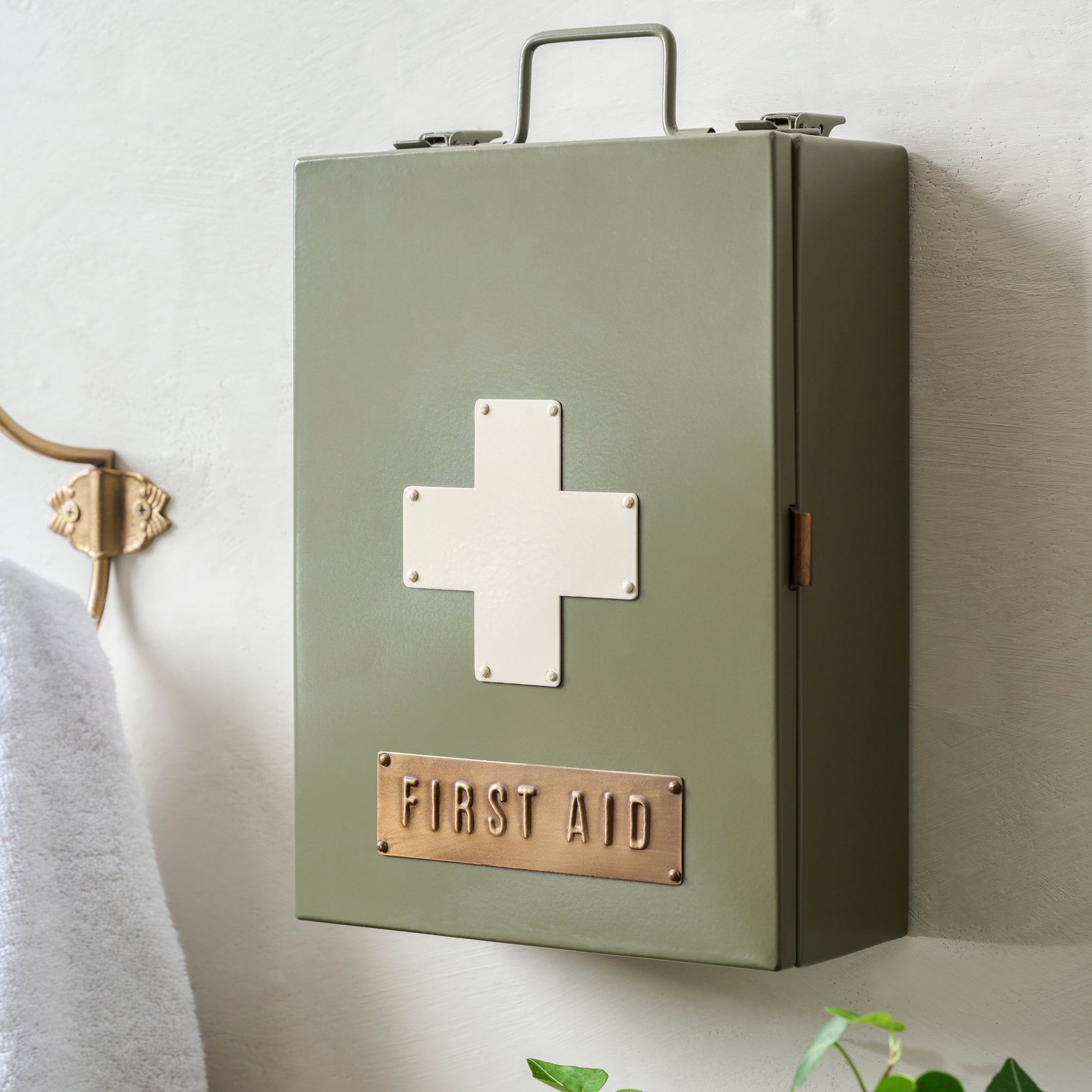 Green First Aid Kit shown closed on wall