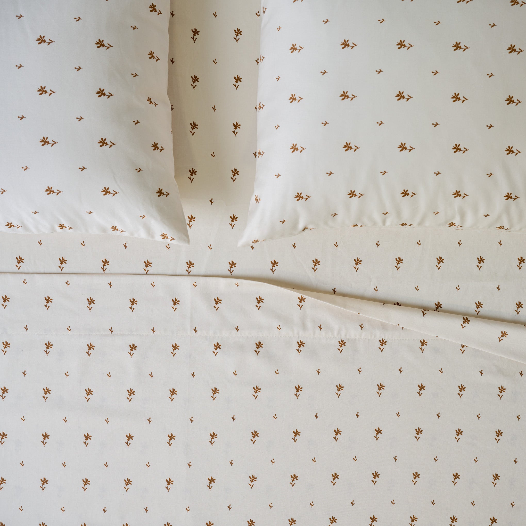 Isla Floral Printed Sheet Set shown on bed Items range from $130.00 to $150.00