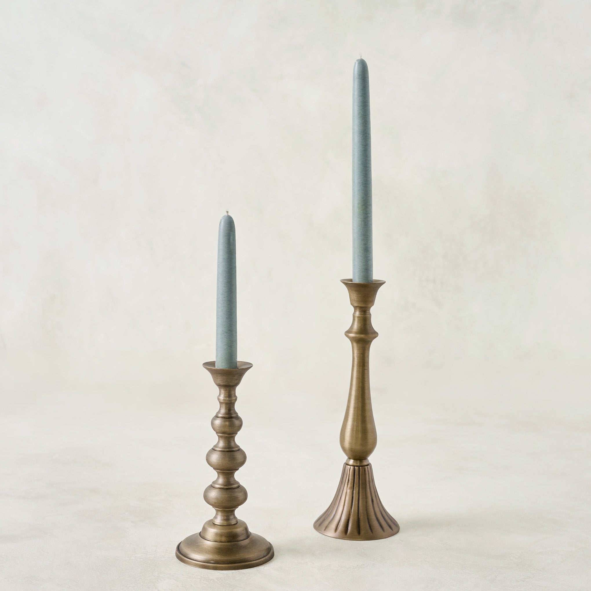 Faris Antiqued Brass Candleholder shown with candles Items range from $24.00 to $26.00