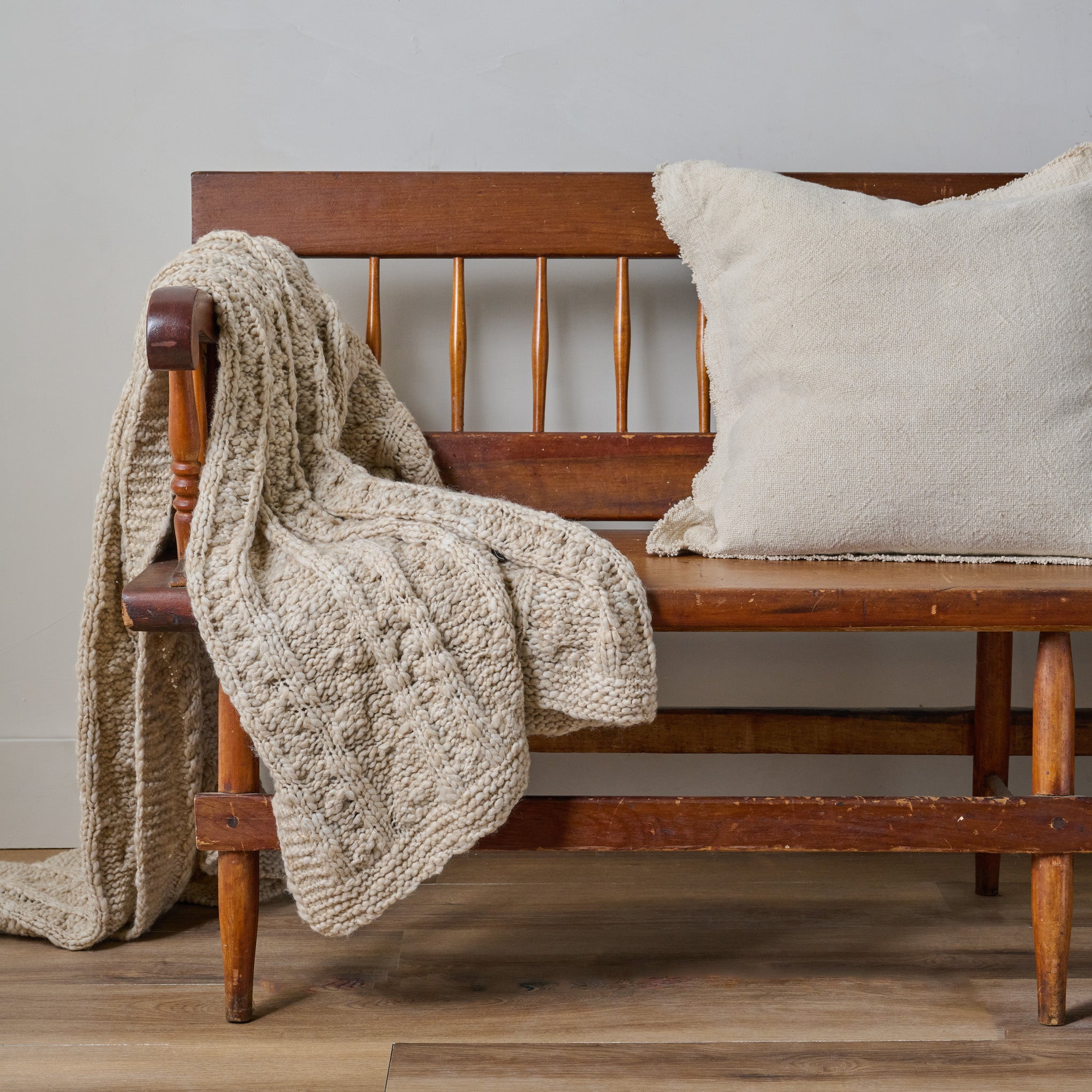 Lina Knit Throw shown draped over bench $118.00