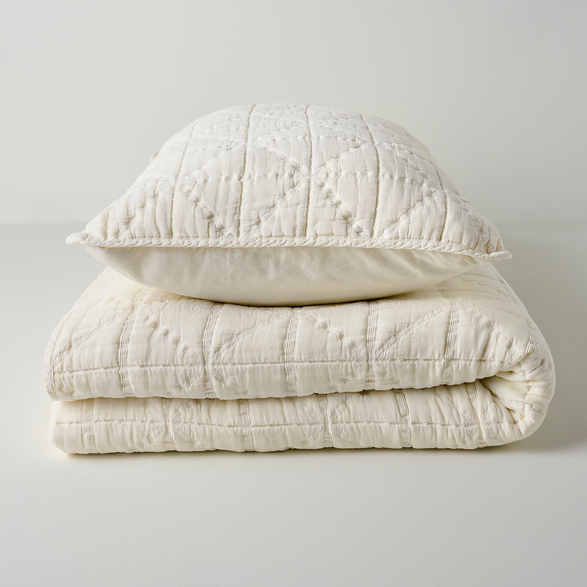 Sutton Cream Matelasse Quilt shown with sham On sale with items ranging from $139.99 to $159.99, discounted from $200.00 to $240.00
