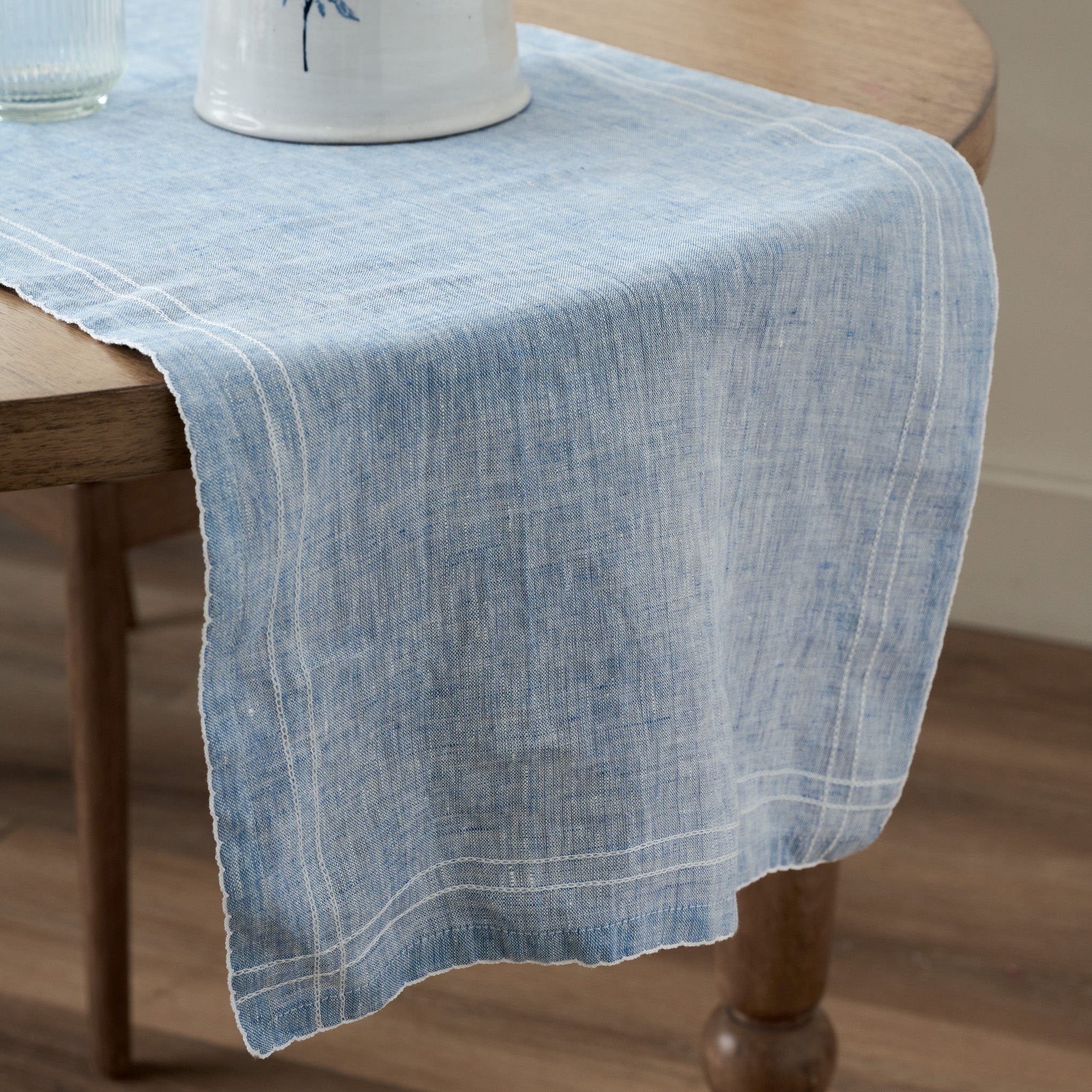 Chambray Embroidered Table Runner shown on table $40.00