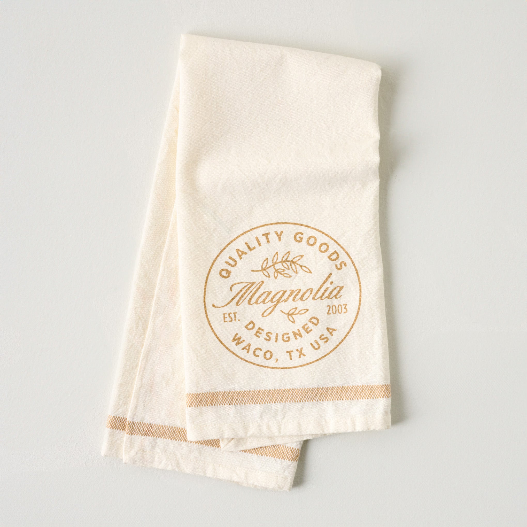 Magnolia Est. Tan Tea Towel $16.00