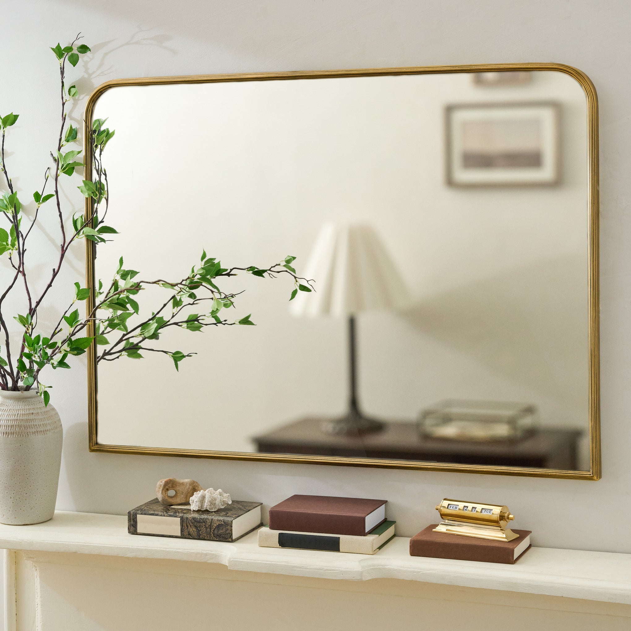 Collin Ribbed Brass Mantel Mirror shown above mantel $188.00