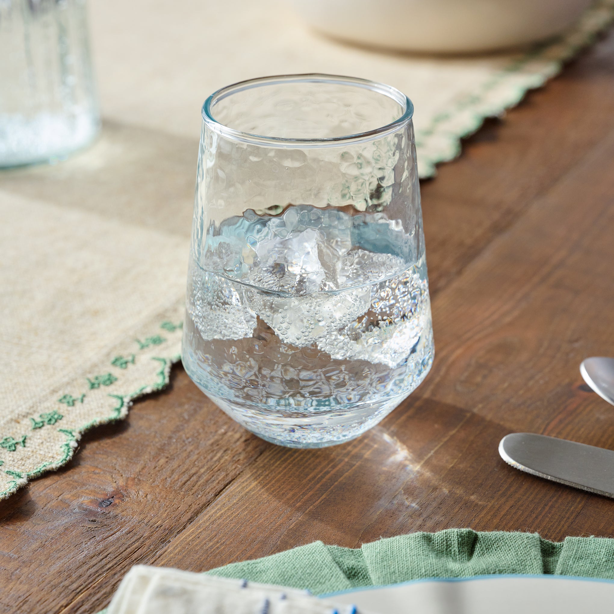 Rustic Glass Stemless Glass shown on table $10.00