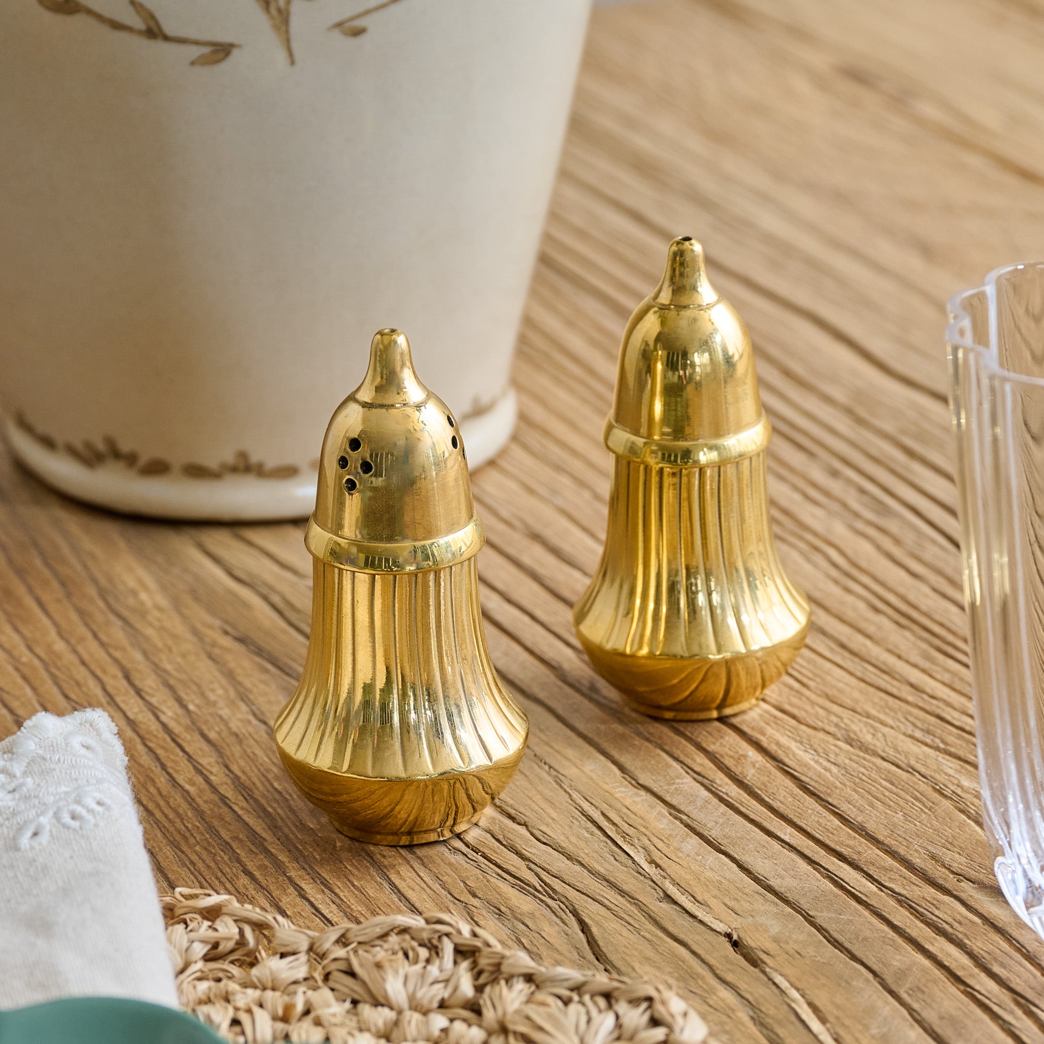 Brass Salt + Pepper Set shown on table $44.00