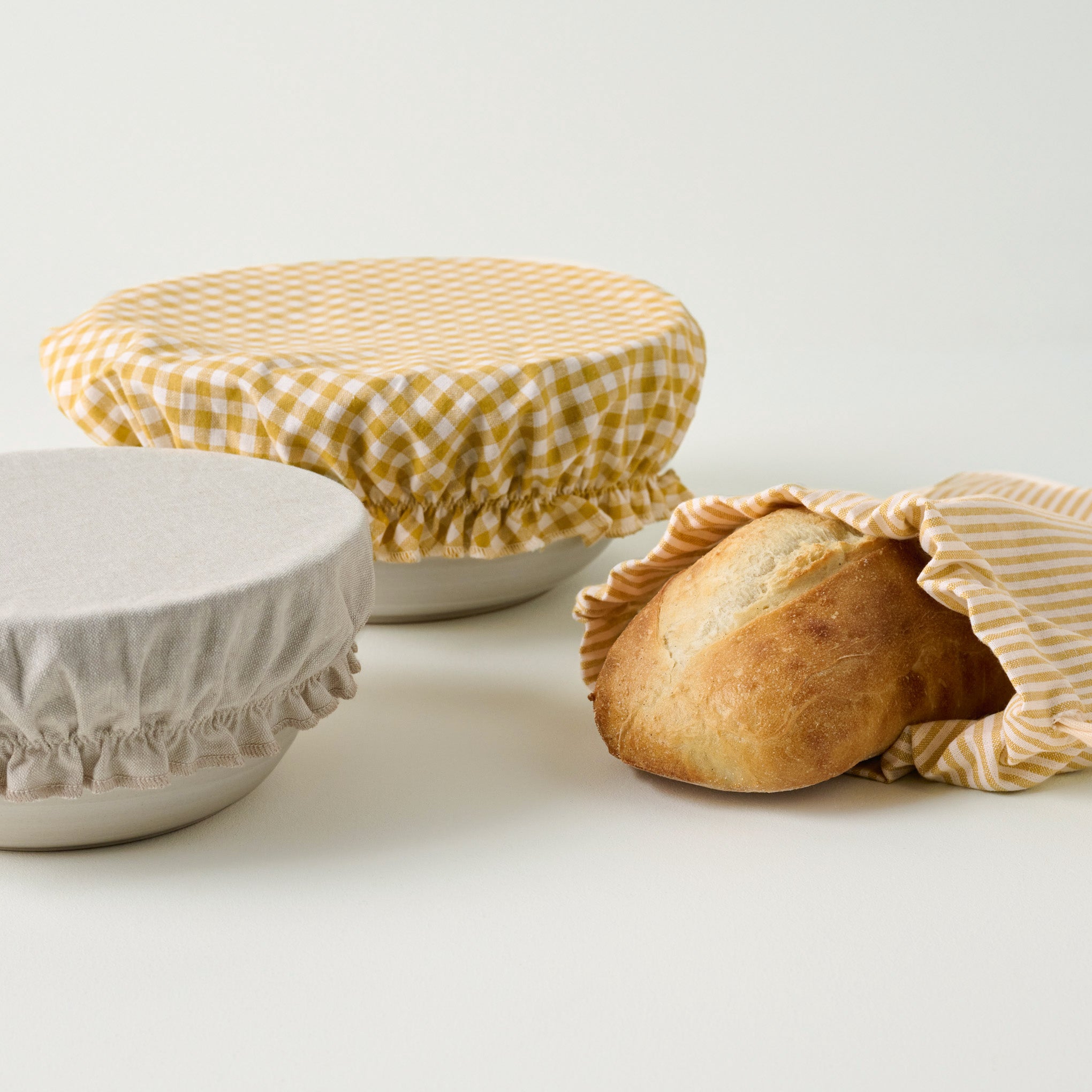 Golden Gingham Bread Bowl Cover and Bag Set shown with bread $38.00